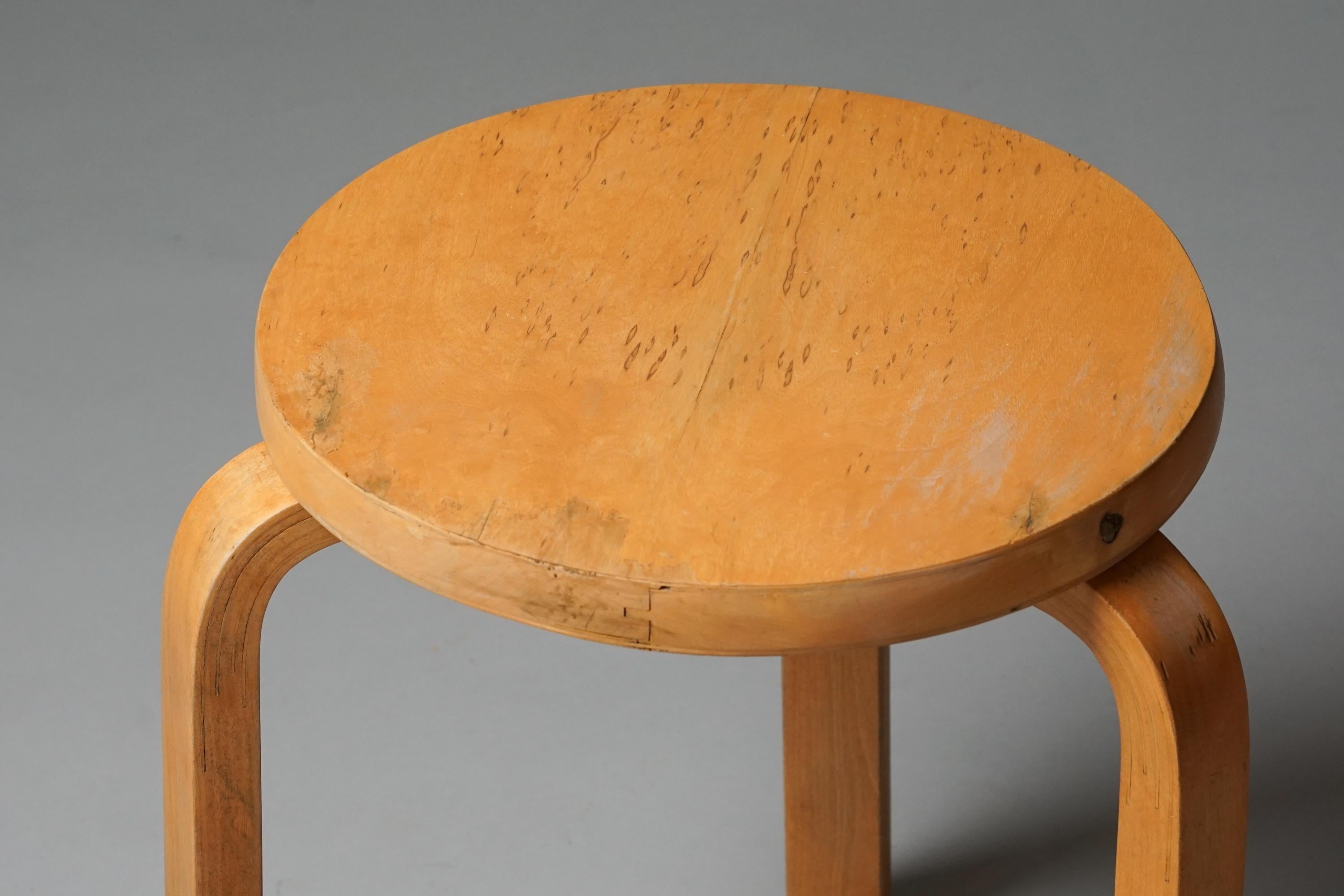 Rare stool model 60, designed by Alvar Aalto, manufactured by Oy Huonekalu- ja Rakennustyötehdas Ab, 1930/1940s. Birch frame, rare carelian birch top. Good vintage condition, patina consistent with age and use. 

Alvar Aalto (1898-1976) is probably