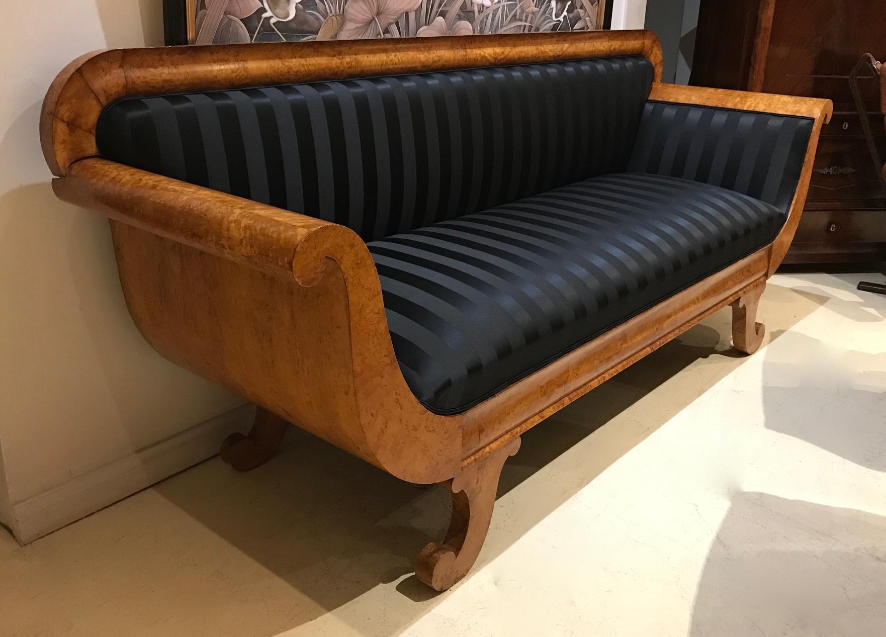 Magnificent Karelian birch sofa with solid sides. 

This sofa base been completely refurbished and reupholstered. 

It is very comfortable and in excellent condition. It is a very solid piece, yet has an elegance given by the curved back and