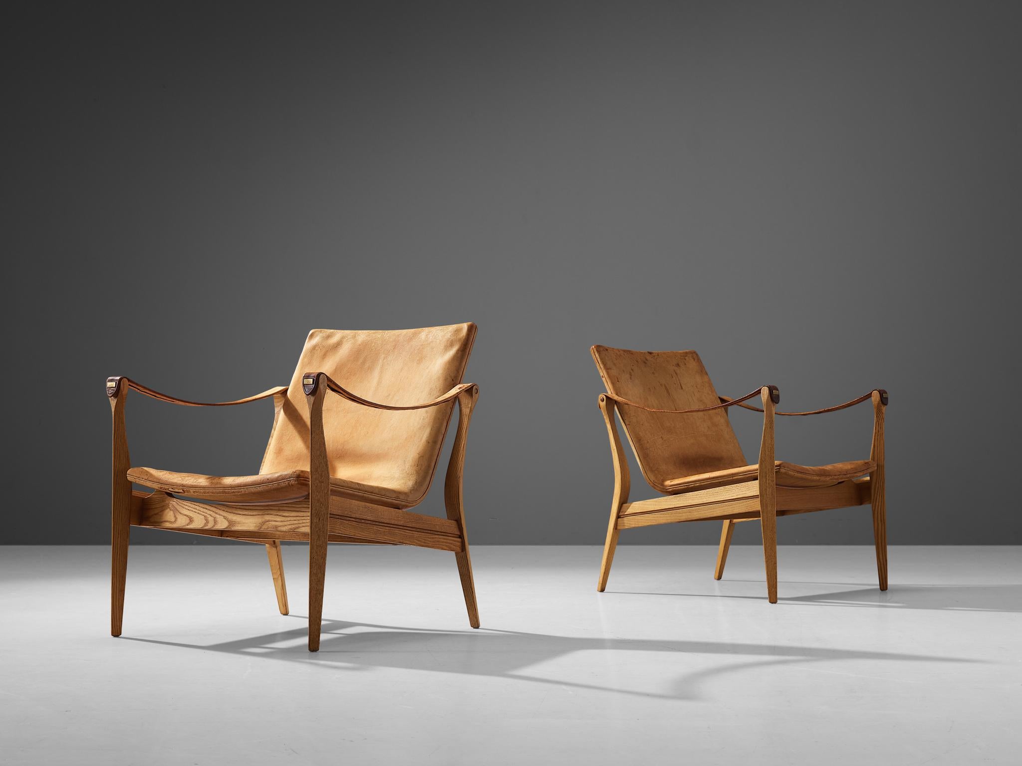 Karen & Ebbe Clemmensen for Ludvig Pontoppidan, safari chairs, ash, leather, Denmark, 1959. 

Stunning pair of safari chairs by Karen & Ebbe Clemmensen for the Danish manufacturer Ludvig Pontoppidan. These chairs are designed in 1959 and contain a
