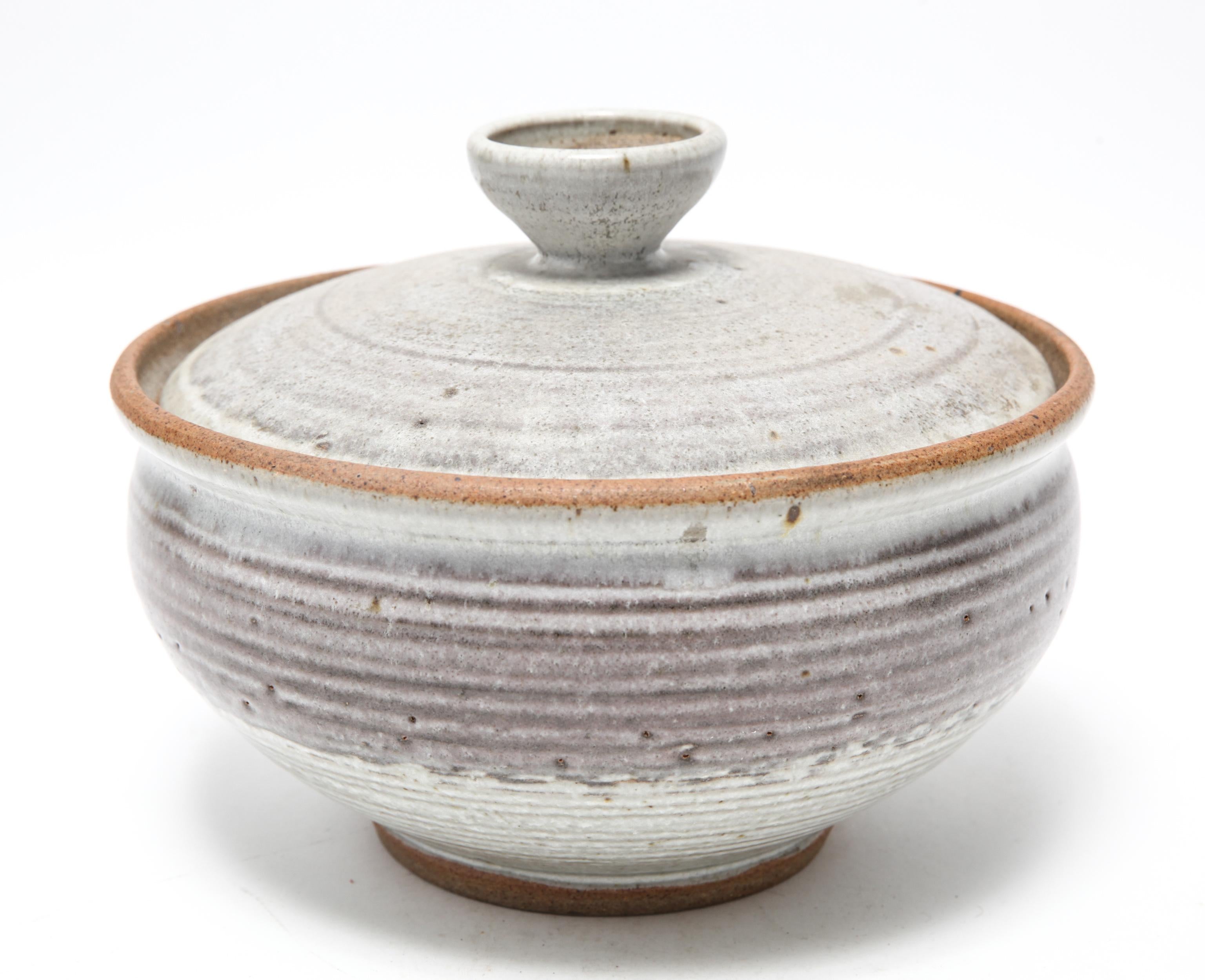American Mid-Century Modern stoneware art pottery covered bowl designed by Karen Karnes (American, 1925-2016) with a cover with knop. The piece is signed with an impressed artist's monogram 