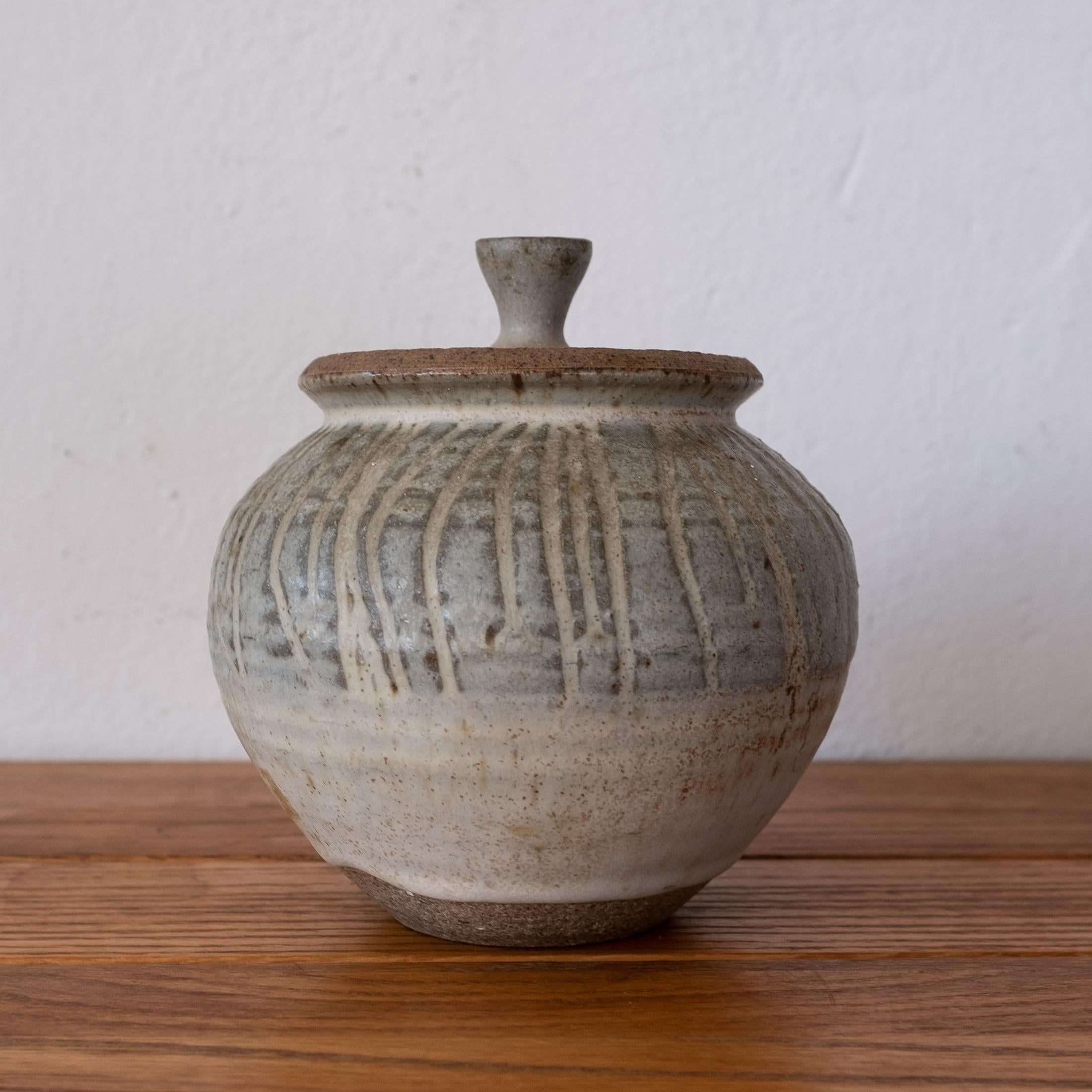 Karen Karnes lidded stoneware vessel. Beautiful incised and subtle glaze. Signed. 1950s

Karnes began a graduate program at Alfred University, but left before completing her degree to work at Black Mountain College. In 1967, Karnes first