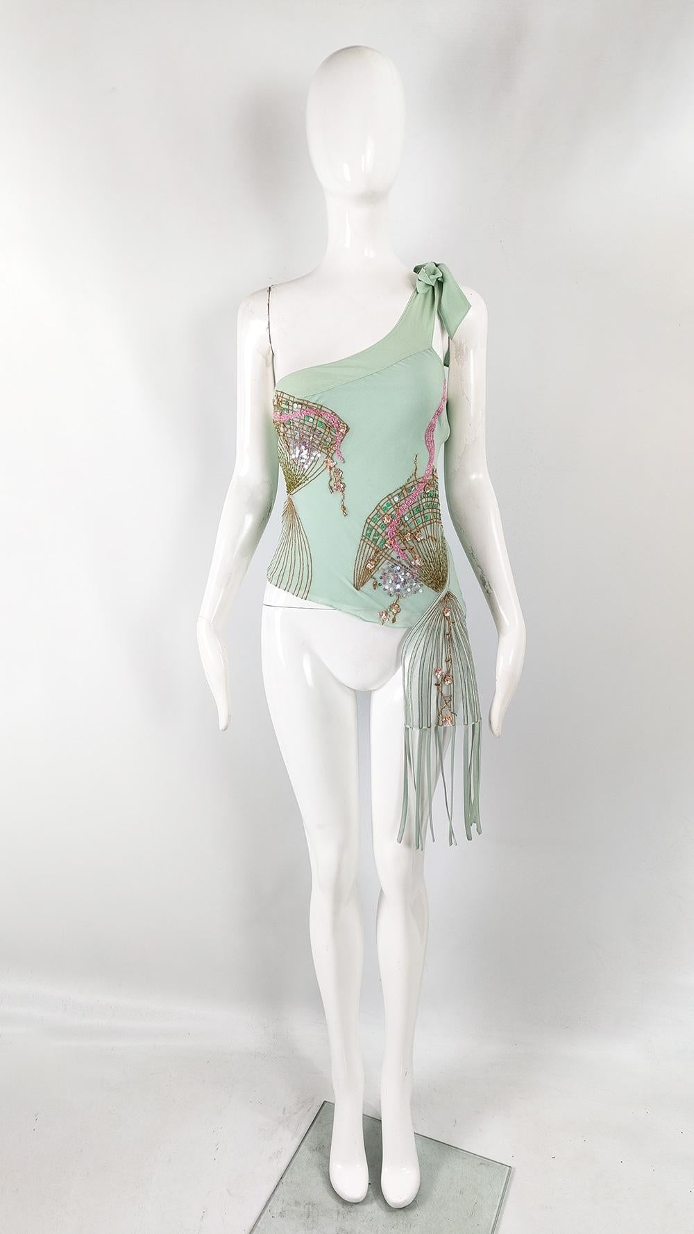 A fabulous and rare vintage womens top from the early 2000s by British label, Karen Millen. In an aqua / pastel turquoise pure silk fabric. It has an asymmetrical, one shouldered design with a tulle mesh on the same side with fringing draping down