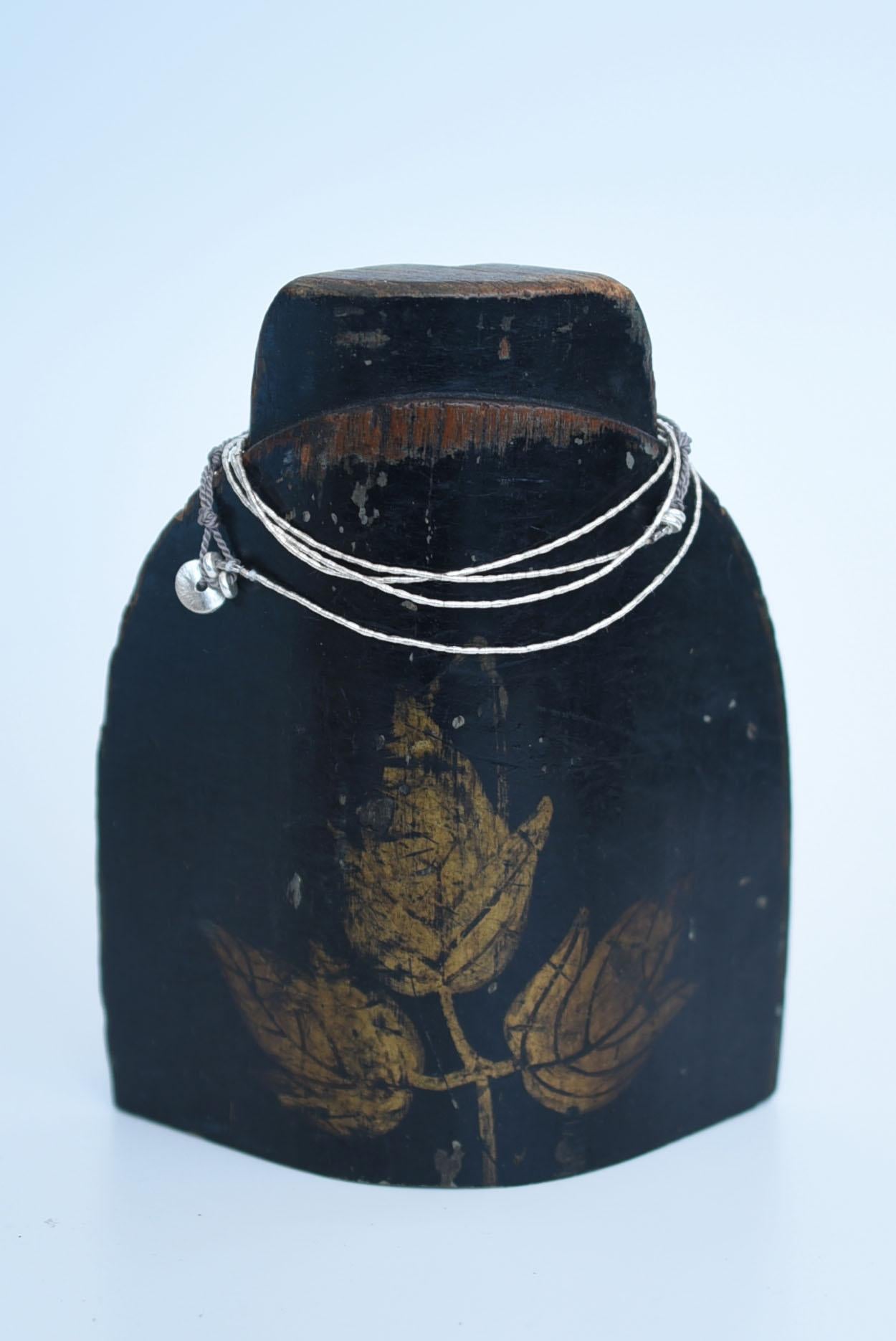 material:karen silver,silk cord
size :length 79cm / weight 3g

The delicate Karen silver chain and silk cord material allow the necklace to be worn in any number of ways. Karen silver, made by the Karen ethnic minority people of Thailand and