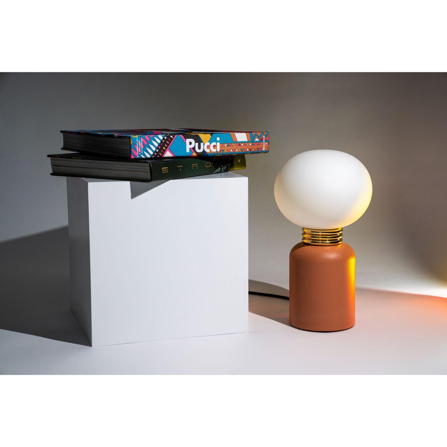 Karen Table Lamp S by Mason Editions.
Dimensions: Ø 19 cm x H 34 cm
Materials: Aluminum, Blown Glass White acid-etched.
Colours: Emerald green, aquamarine, cotto, taupe, pink, burgundy. Colors with upper case.

All our lamps can be wired according