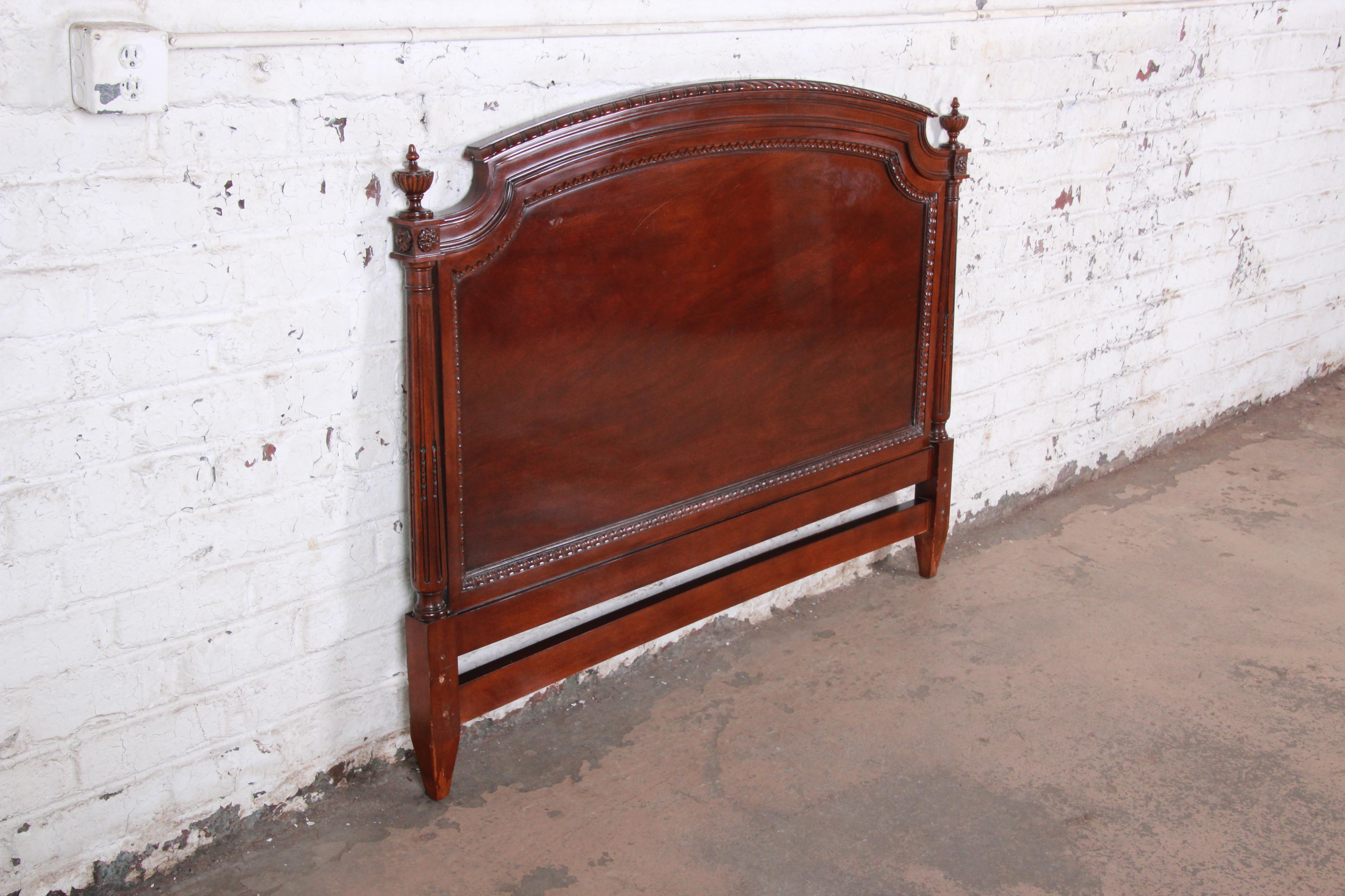 A gorgeous carved mahogany queen size headboard by Karges. The headboard features stunning mahogany wood grain with elegant carved details and a nice traditional style. Made with the highest level of craftsmanship and quality as expected from