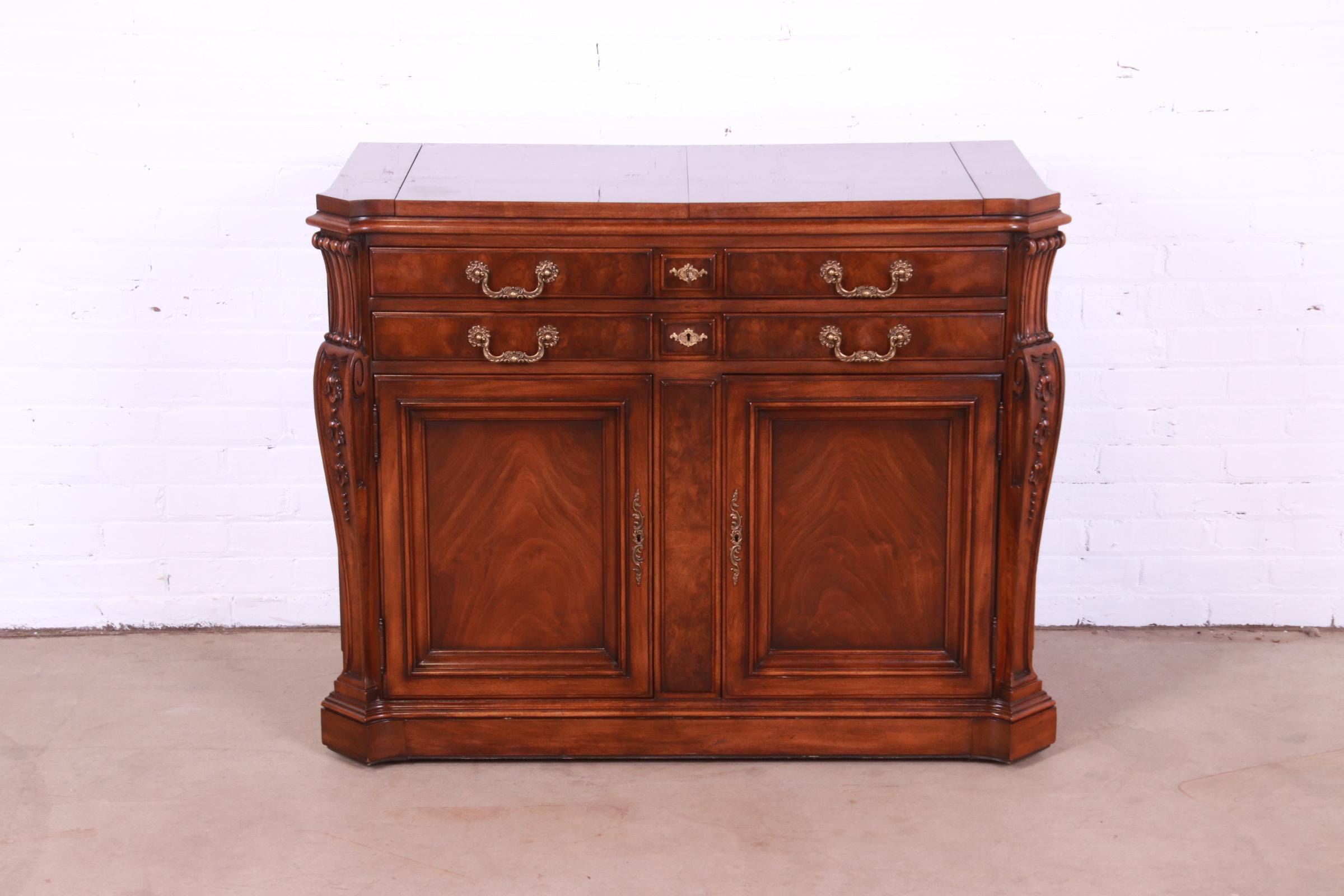 An exceptional French Louis XV style flip top rolling server or bar cart

By Karges

USA, Circa 1980s

Gorgeous figural burled walnut, with original brass hardware and felt silverware inserts in drawers. Drawers lock, and key is