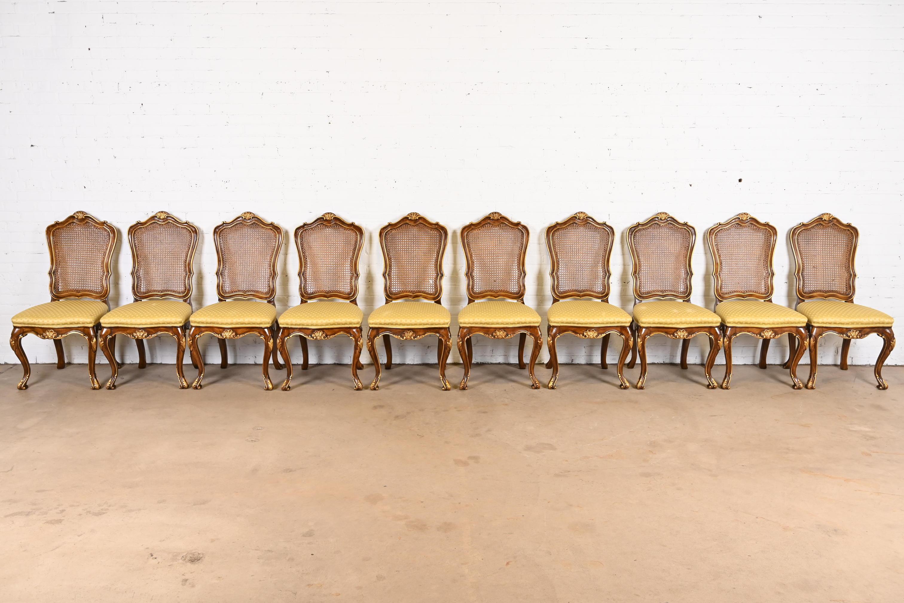 An outstanding set of ten French Provincial Louis XV style dining chairs

By Karges Furniture

USA, Circa 1980s

Gorgeous carved solid walnut frames, with gold gilt details, caned backs, and upholstered seats.

Measures: 20.5