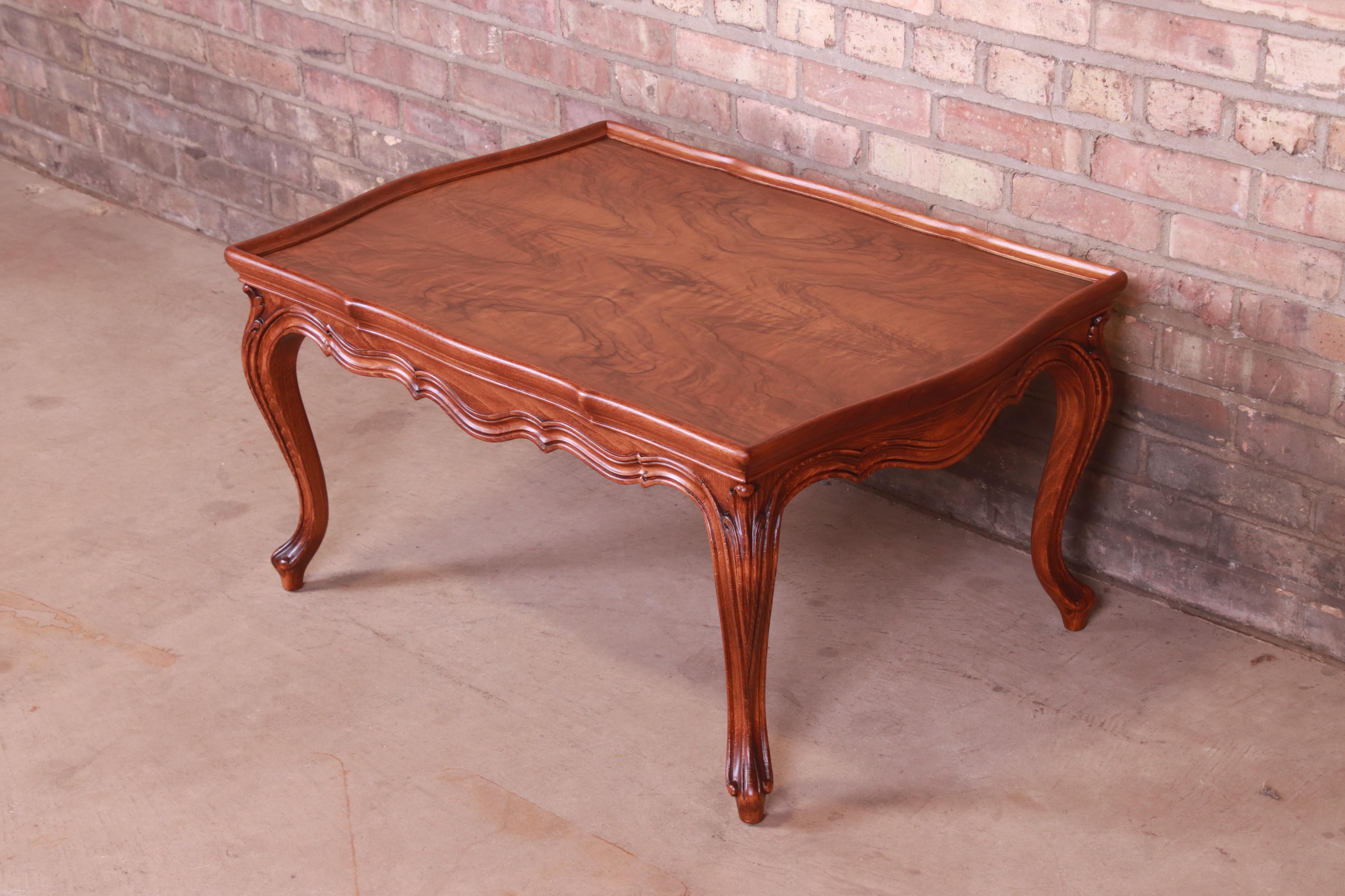 A gorgeous French Provincial Louis XV style coffee table

By Karges Furniture

USA, Circa 1960s

Book-matched burled walnut top, with carved solid walnut legs.

Measures: 34