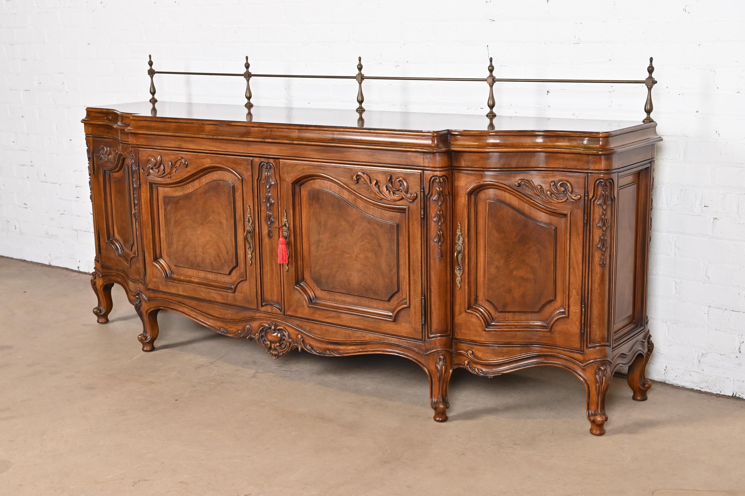 A gorgeous French Provincial Louis XV style sideboard buffet, credenza, or bar cabinet

By Karges

USA, Circa 1980s

Carved walnut, with burled walnut door fronts, and original brass hardware and gallery.

Measures: 81.5