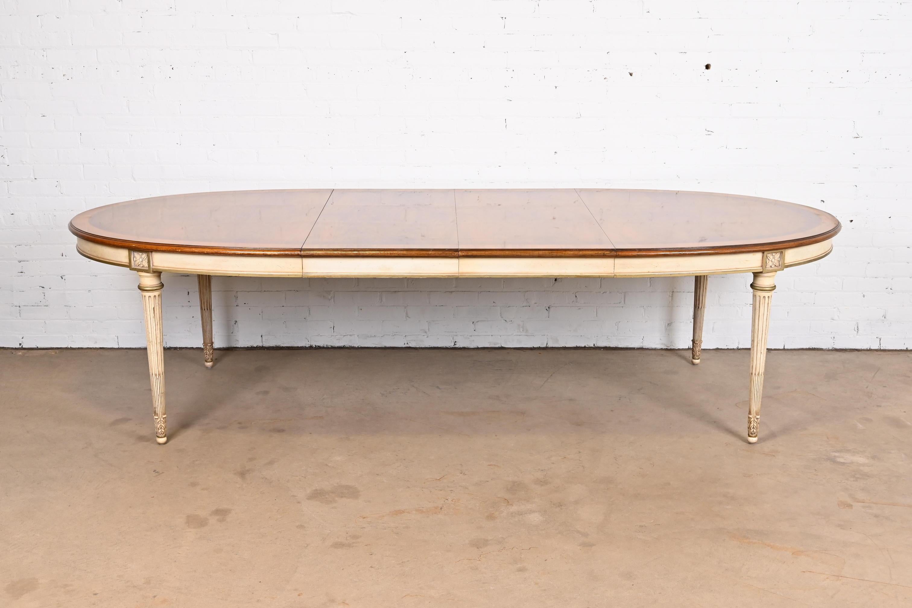 An exceptional French Regency Louis XVI style extension dining table

By Karges Furniture

USA, Circa 1960s

Gorgeous book-matched burled walnut, with cream and gold painted apron and legs.

Measures: 72