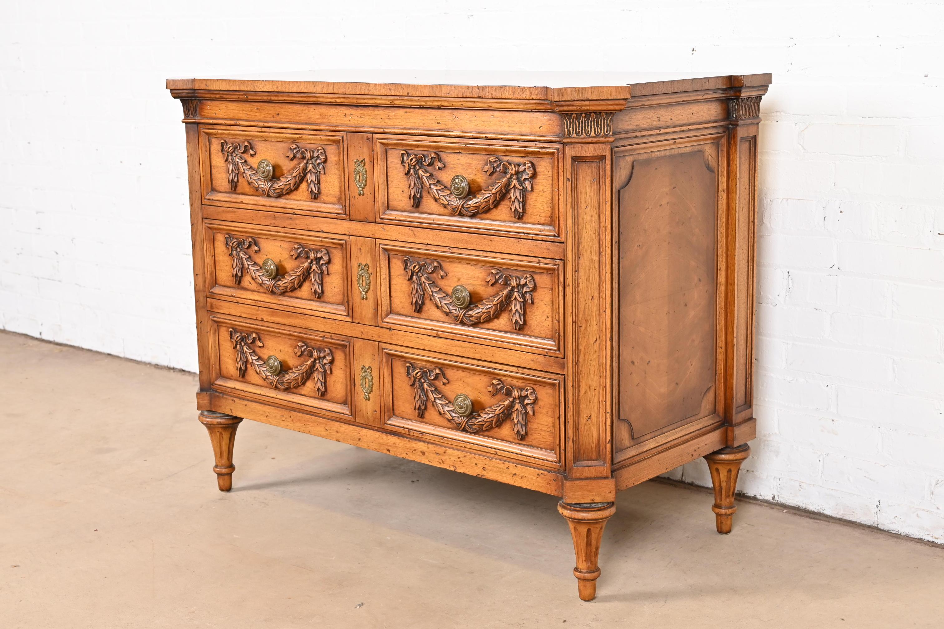 A gorgeous French Regency Louis XVI style three-drawer server, dresser, or chest of drawers

By Karges

USA, Circa 1960s

Carved burled walnut, with original brass hardware.

Measures: 43.25