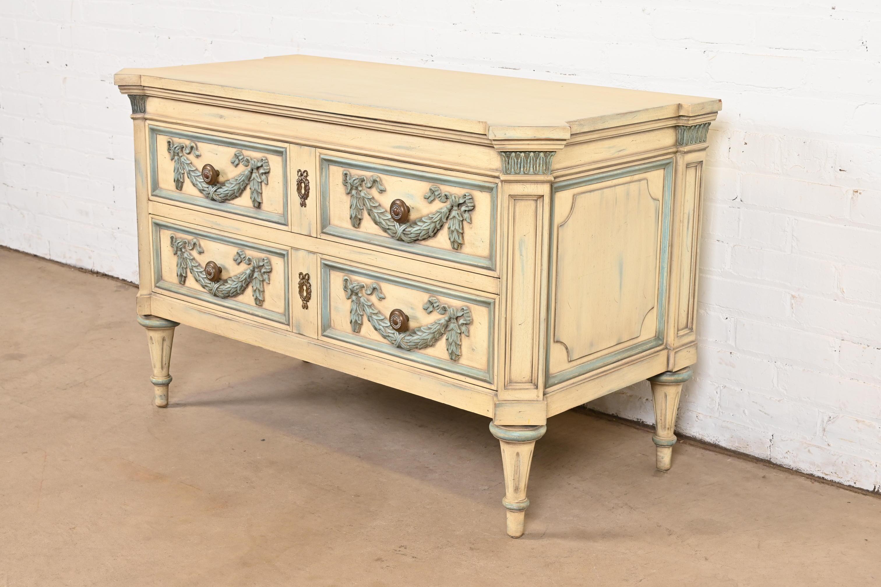 A gorgeous French Regency Louis XVI style two-drawer server, dresser, or chest of drawers

By Karges

USA, Circa 1960s

Carved walnut, with original cream and light blue painted finish, and original brass hardware.

Measures: 43.25