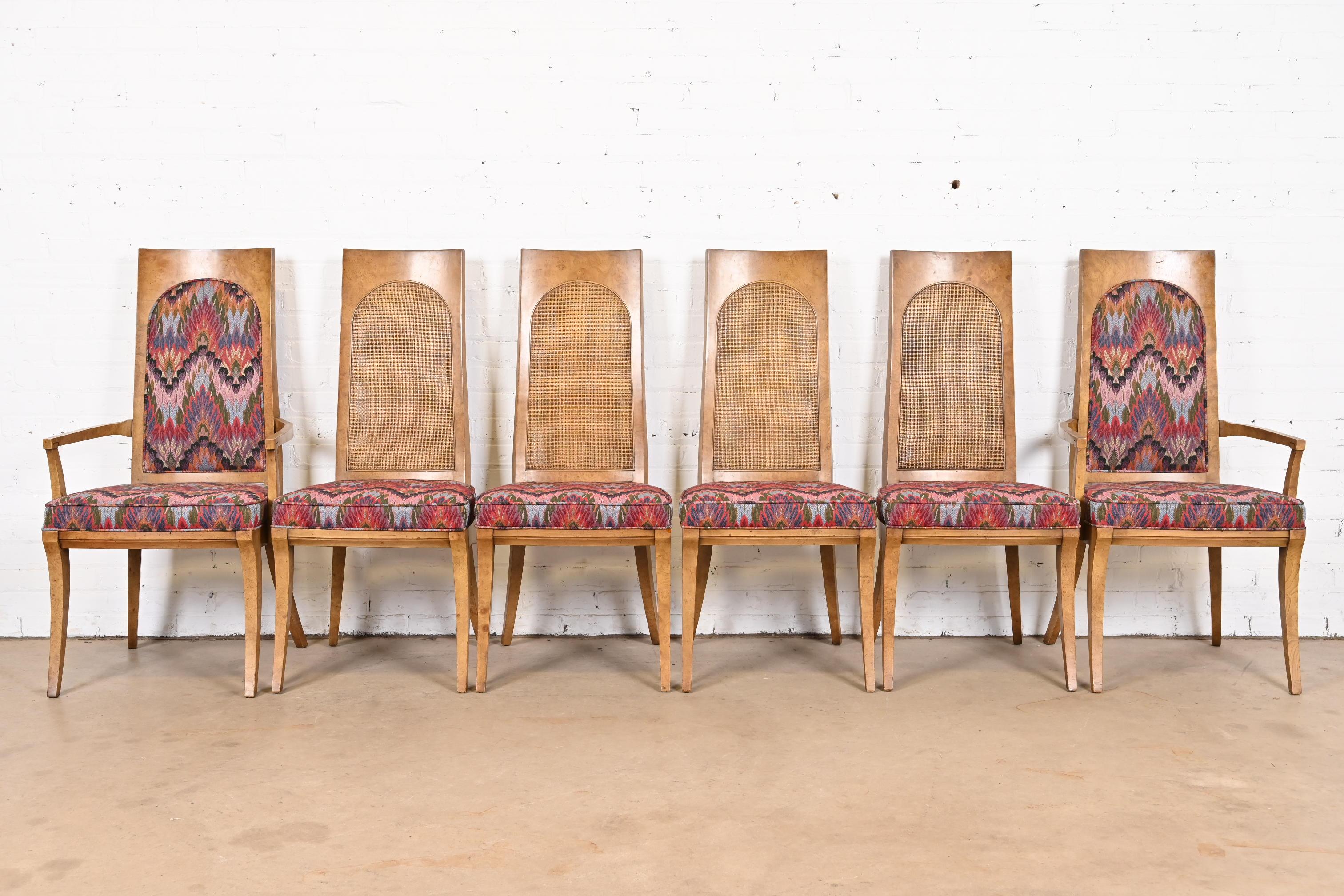 An outstanding set of six Mid-Century Modern Hollywood Regency dining chairs

By Karges Furniture

USA, Circa 1960s

Gorgeous burl wood frames, with caned backs, and peacock patterned upholstery.

Measures:
Side chairs: 19