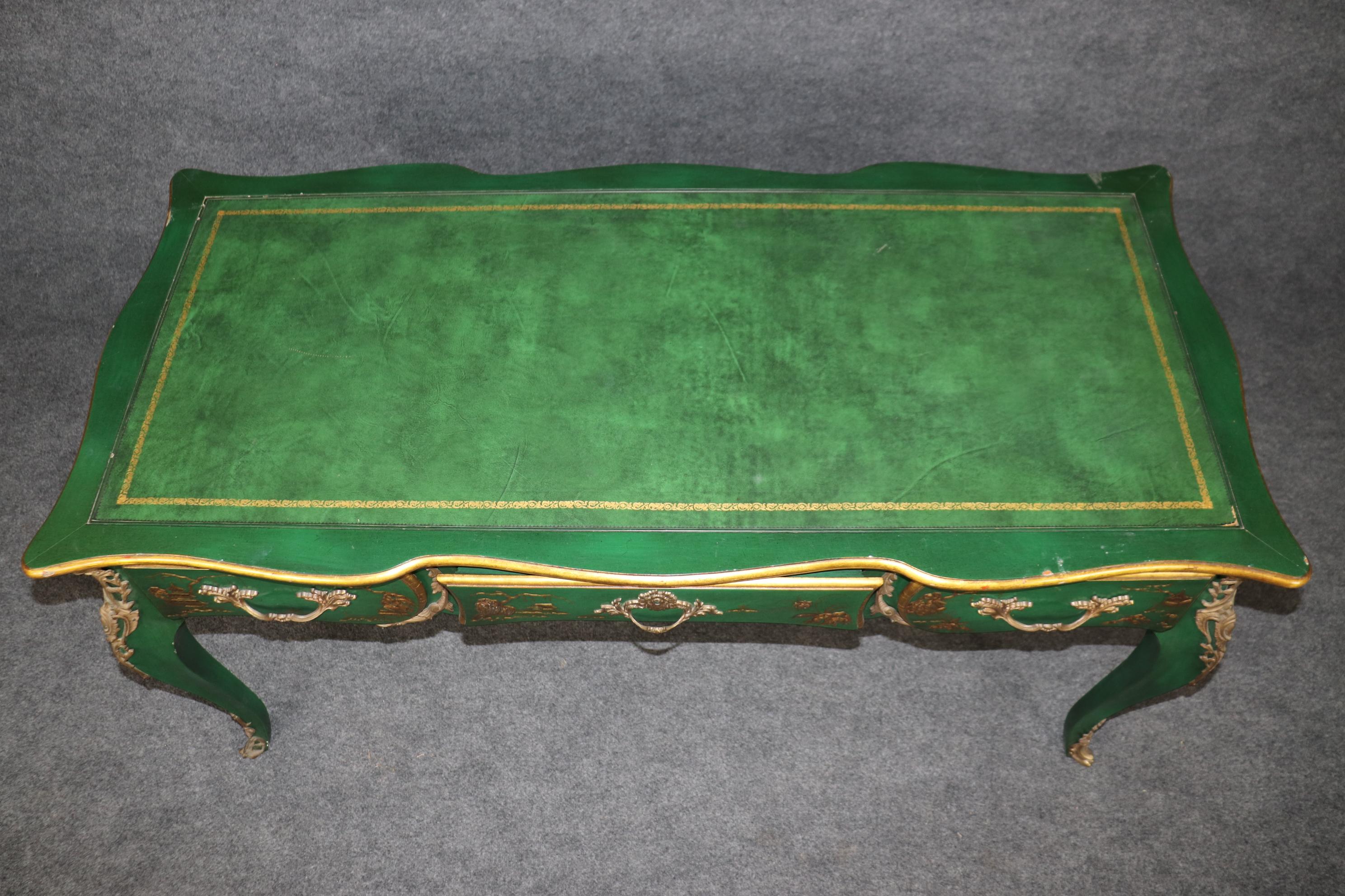 This is a gorgeous time-worn green chinoiserie desk done in the Louis XV style with raised Green and gold painted chinoiserie decoration. The desk is in good condition and will show signs of age and wear. It looks like an antique desk. Made during
