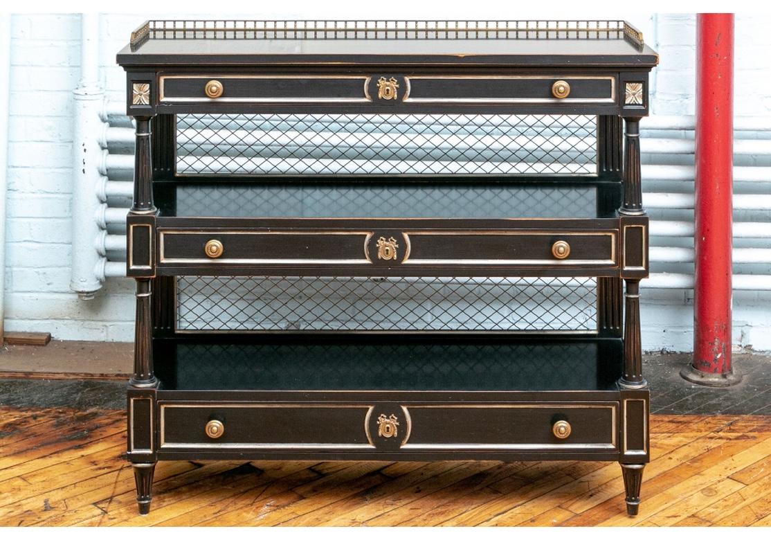 A finely crafted walnut three-tiered server in an Ebonized finish. The top with a 3/4 brass gallery, and each tier with a long drawer with fine French style cast brass mounts, and silvered edges. The top drawer lined in felt for flatware storage.