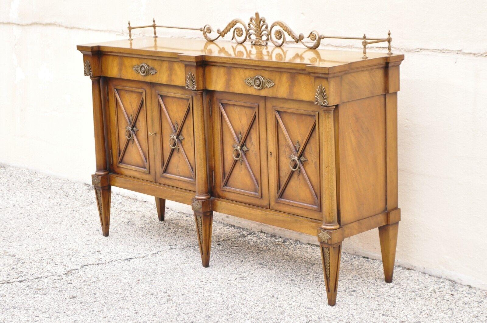 Karges Neoclassical Regency style mahogany sideboard buffet with brass ormolu. Item features a tall metal gallery, carved x-form door fronts, brass ormolu, carved column supports, 4 swing doors, 2 wooden shelves, tapered legs, matching cabinets