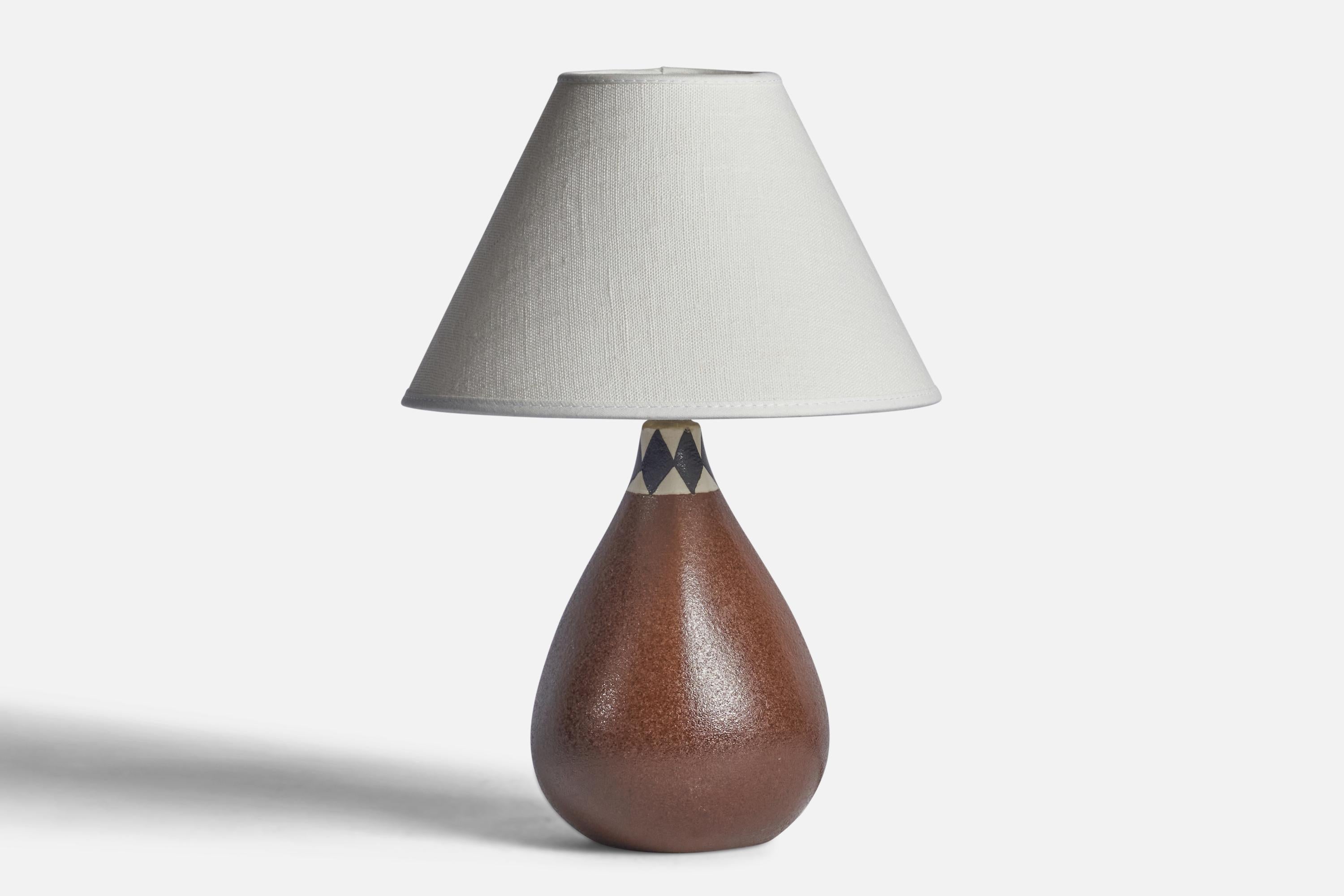 A brown white and black-glazed stoneware table lamp designed and produced in Sweden, 1960s.

Dimensions of Lamp (inches): 8.75” H x 4.5” Diameter
Dimensions of Shade (inches): 3” Top Diameter x 8” Bottom Diameter x 5” H 
Dimensions of Lamp with