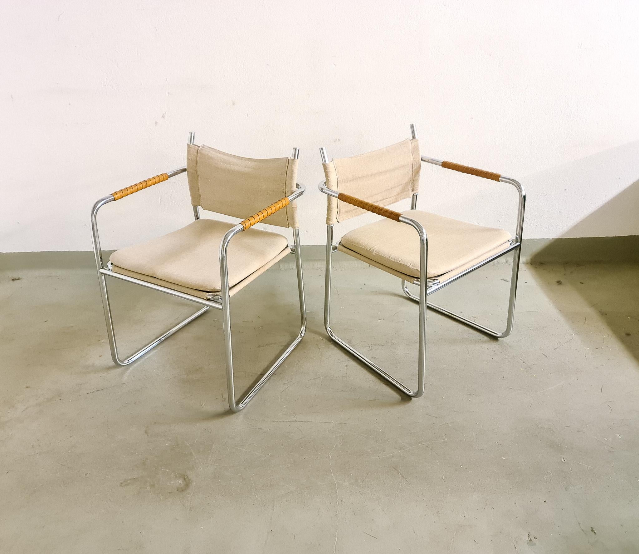 Armchairs model Amiral designed by Karin Mobring, 1971. Produced by Ikea in Sweden.
These ones are sold as a pair. This pair is made in tubular steel frame with handles wrapped in leather. The upholstery is made by canvas and so are the