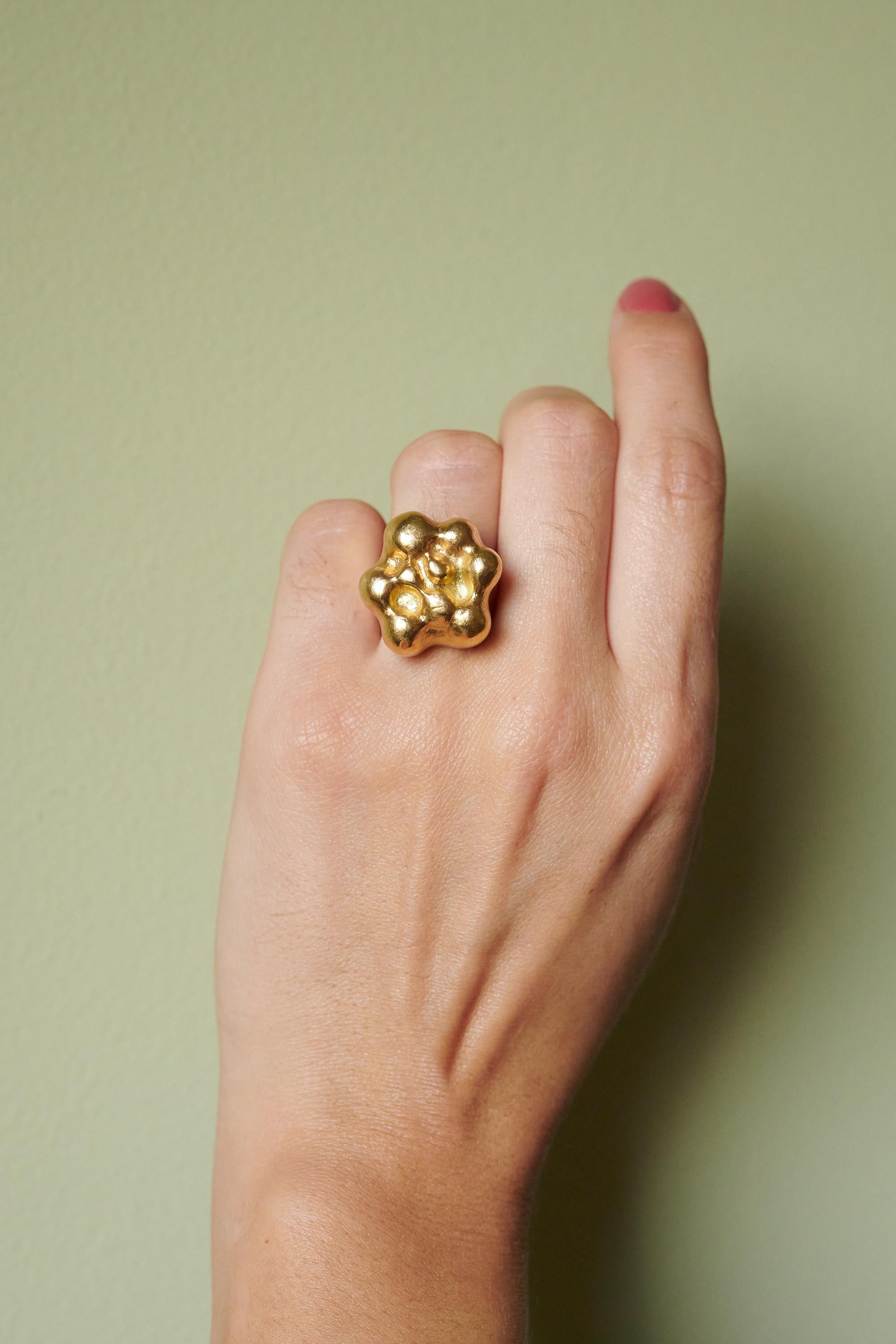 A hand-shaped, cast 18 karat gold 