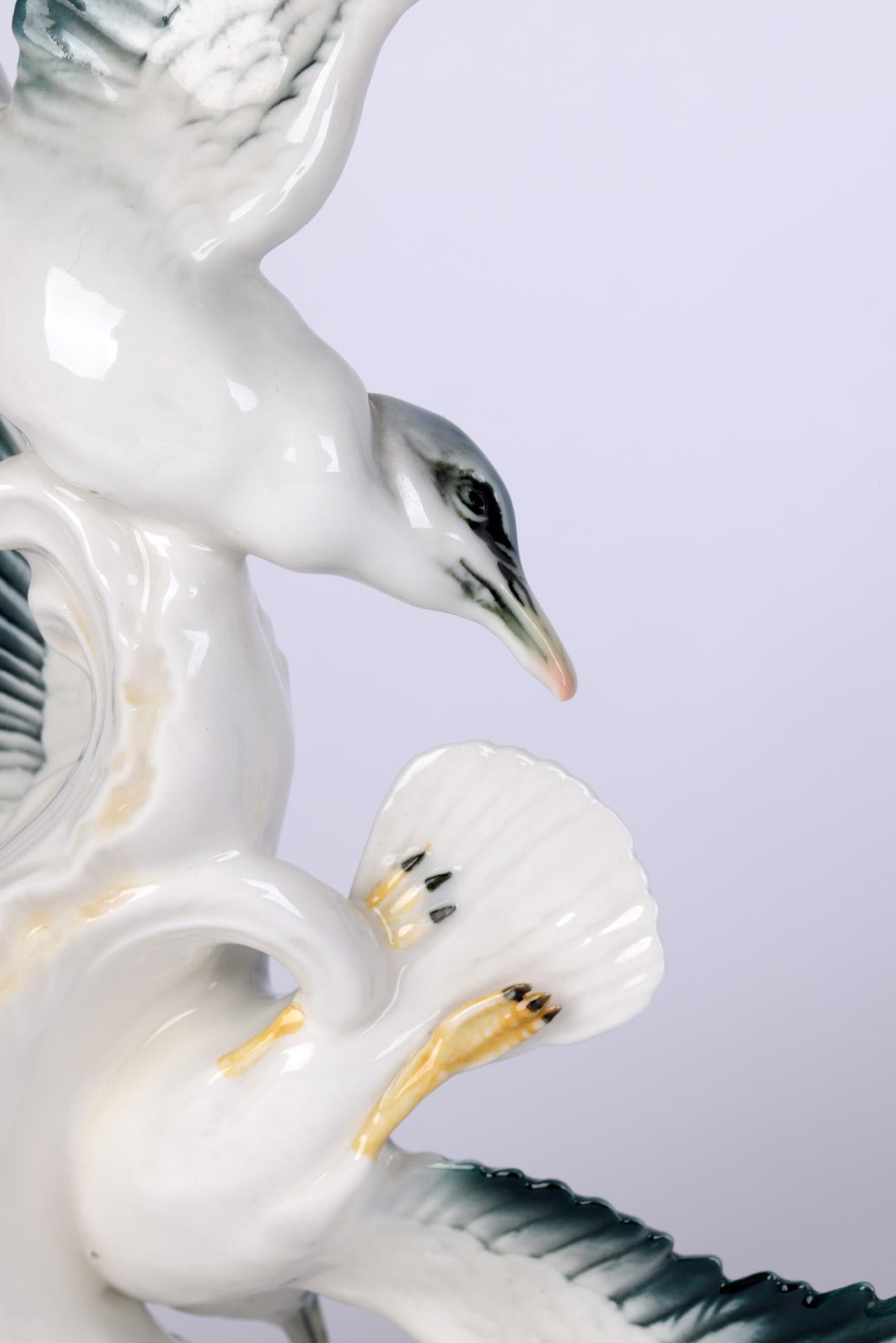 A wonderful German porcelain portrayal of two swooping seagulls by renowned porcelain maker Karl Ens Volkstedt made between 1919 and 1945. The figures are finely modelled and mounted on a tall wave shaped base with wings overlapping and swooping