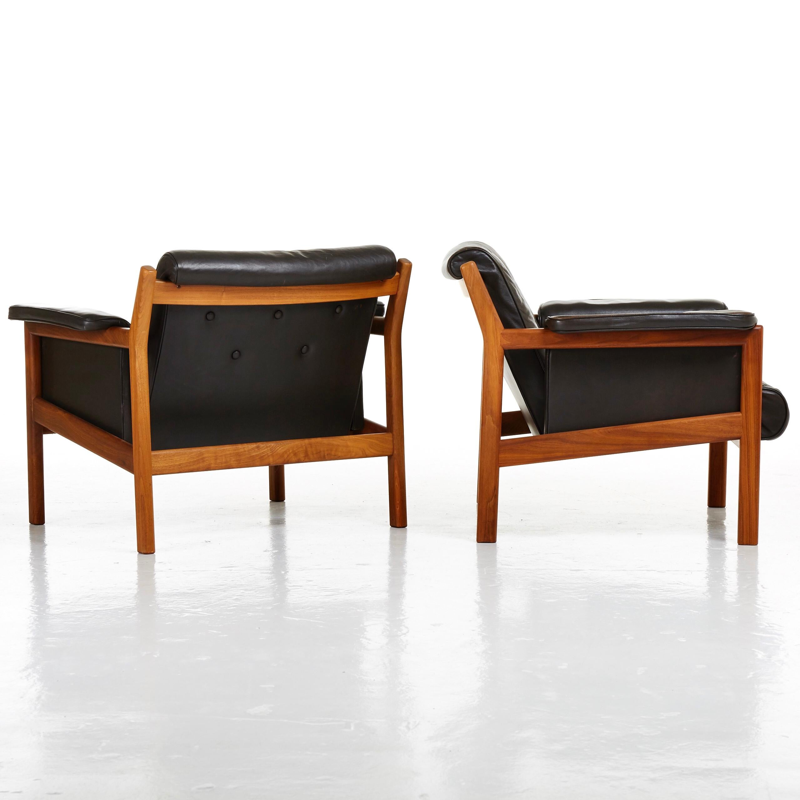 Pair of easy chairs designed by Karl-Erik Ekselius, made in solid teak wood and leather. Produced by JOC in Vetlanda, Sweden in 1960s.