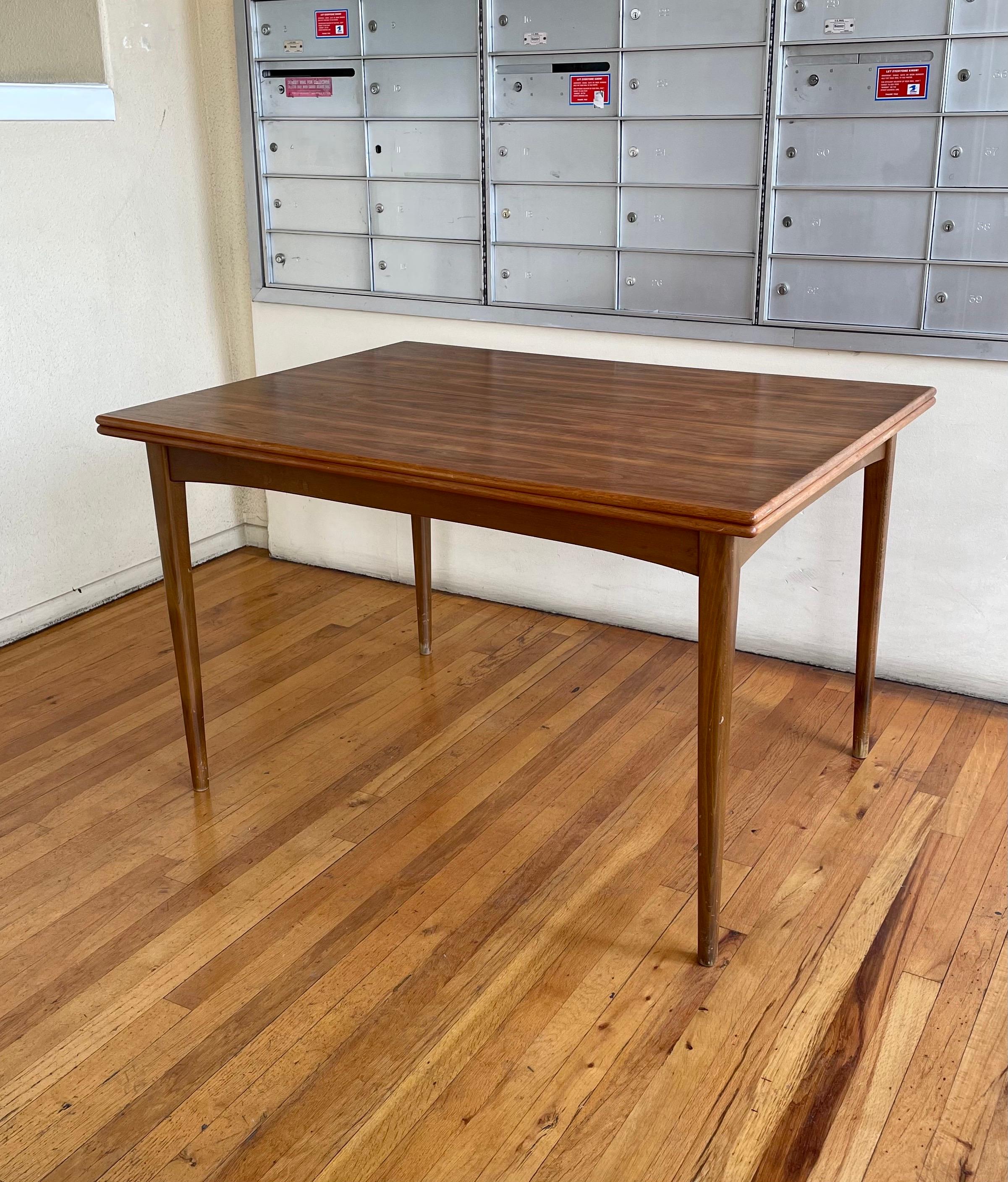 Walnut and beechwood dining table by Karl-Erik Ekselius Model-1401 expanding dining table for DUX, the top folds and swivels this table it's in its original condition we didn't refinish it because it's in very good condition when it's open its