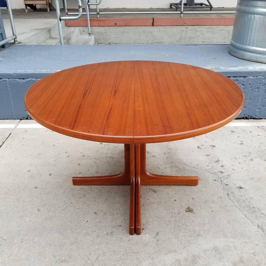 Fine Scandinavian Modern expanding dining table by Karl-Erik Ekselius for JOC Mobler, Sweden, circa 1960. Solid teak split pedestal base may be configured as a circular or oval table. Includes two 23.5 inch table leaves. Table as round measures 47