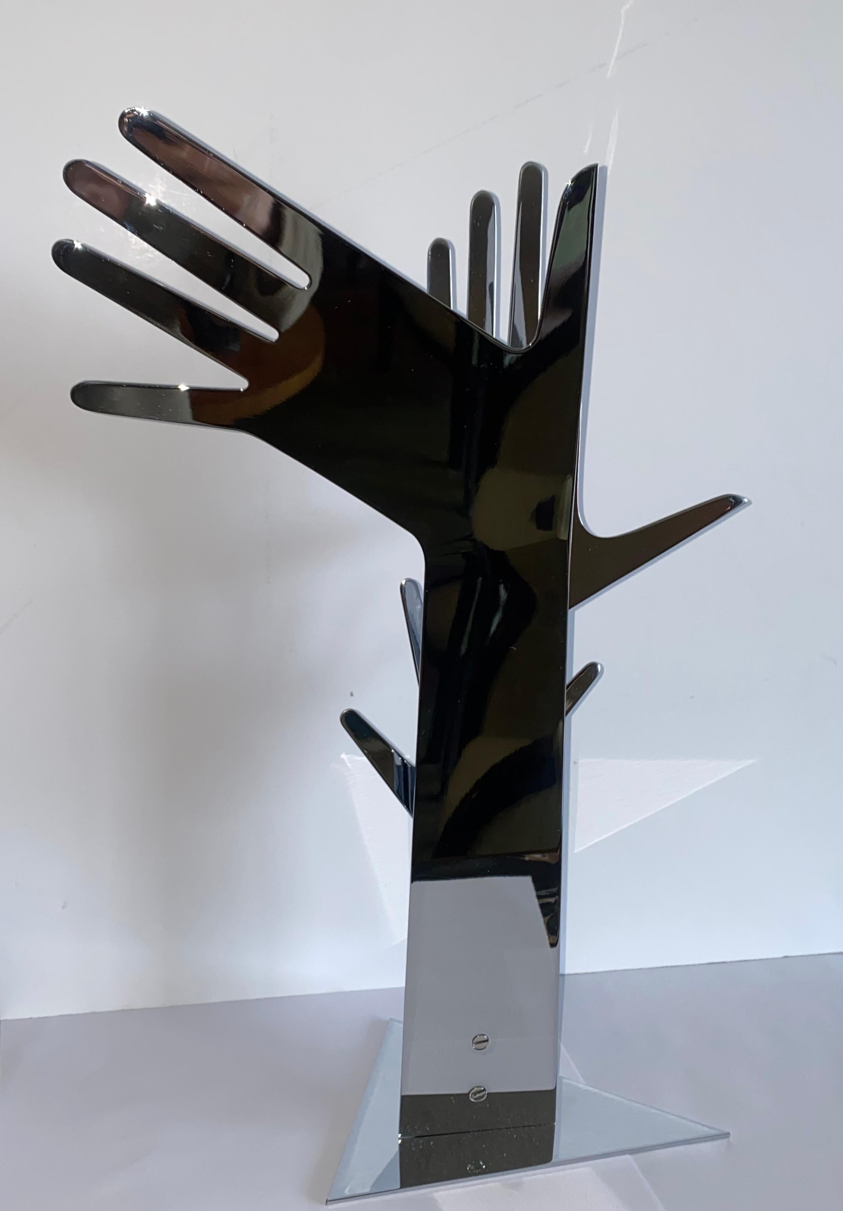 A fantastic chromed sculpture of three hands. This beautiful sculpture was made by Karl F. Schmidt, who apprenticed with Franz Hagenauer and worked his way up to factory head/executive director at Werkstätten Hagenauer before leaving to found his