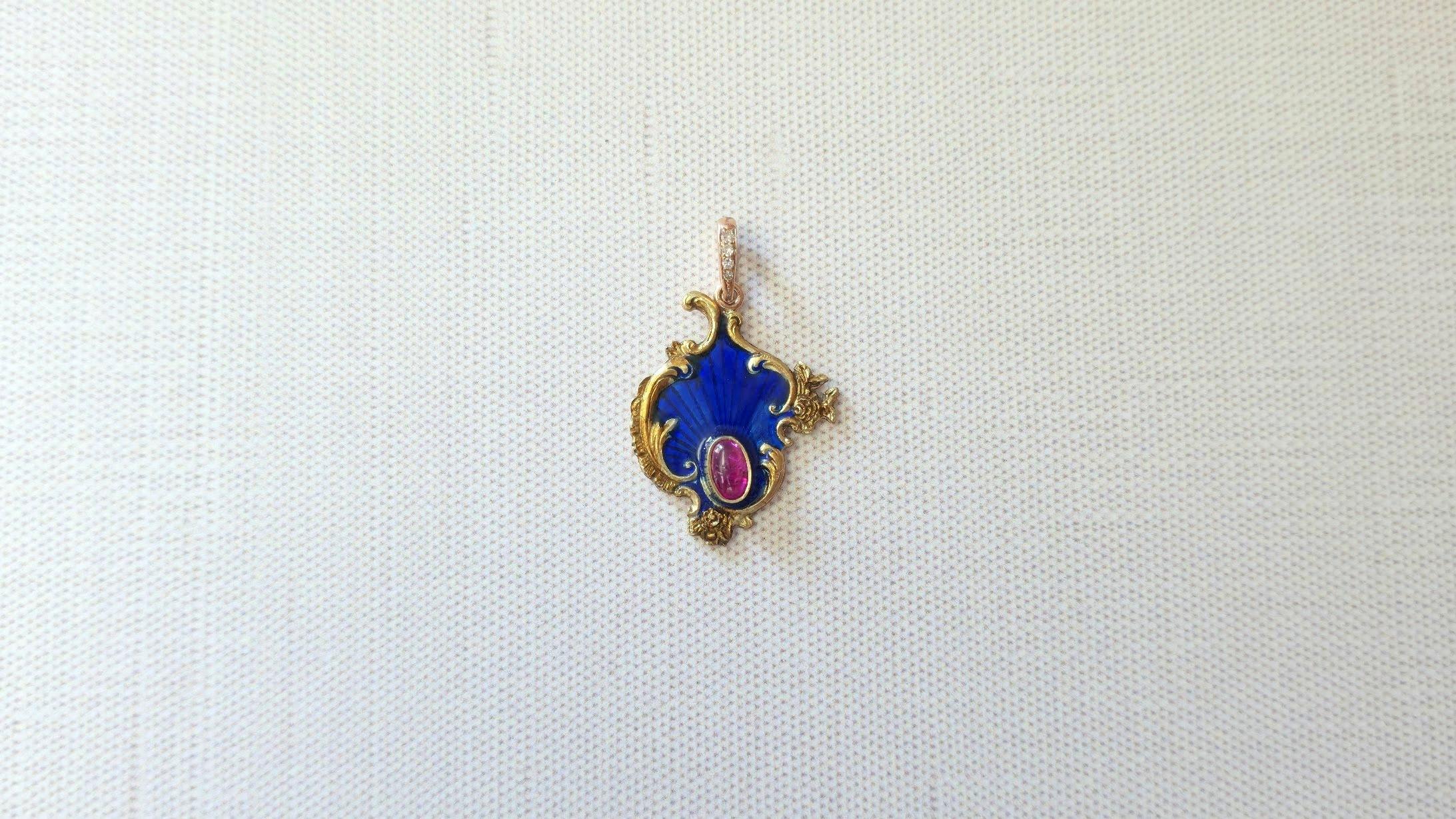 We are pleased to present another unique piece worthy of a place in your collection – a gold-enamel pendant adorned with a large ruby cabochon, created by the legendary Karl Fabergé.

The pendant is crafted from yellow and pink gold with blue