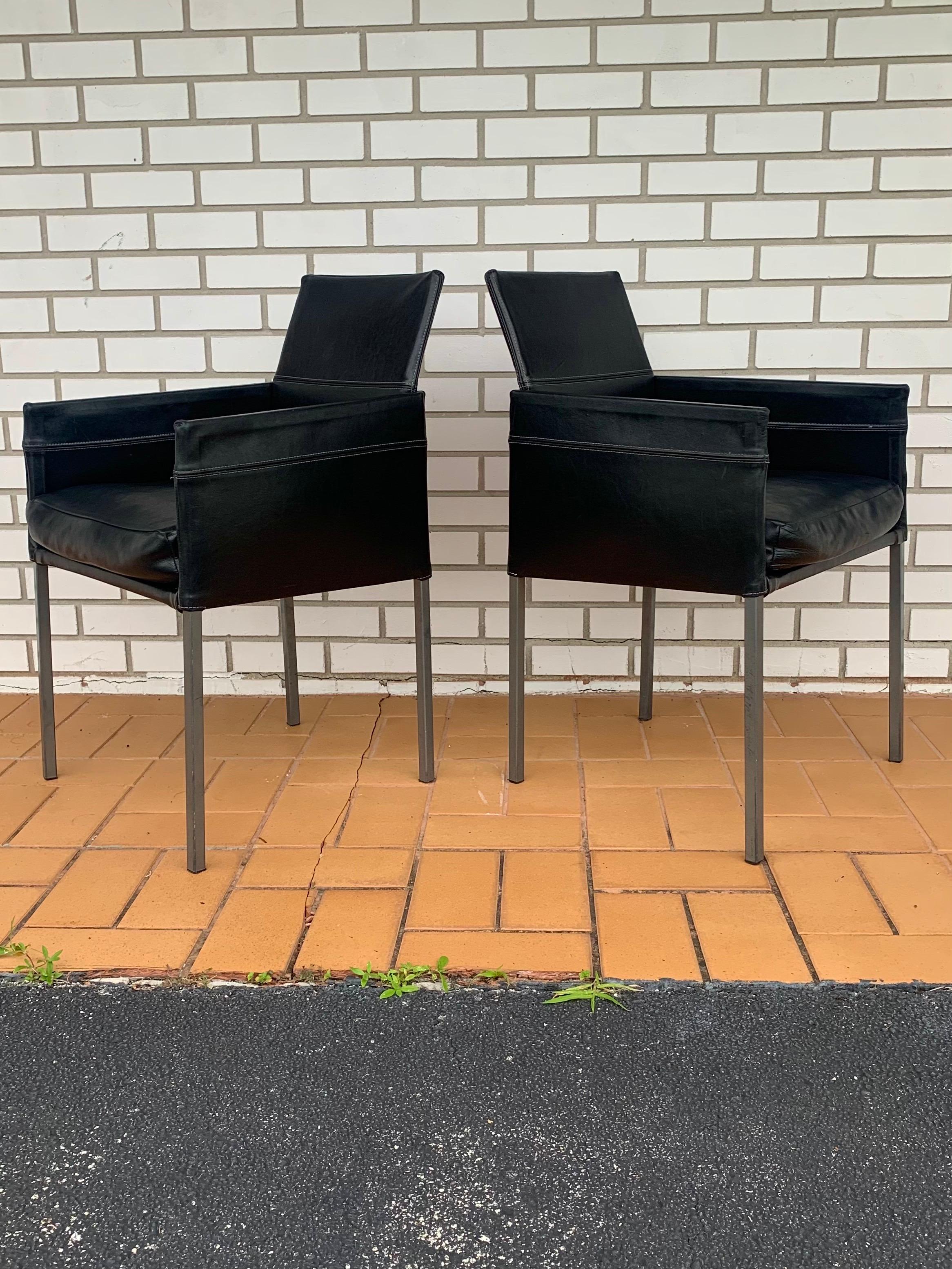 Pair of arm chairs designed by Karl Friedrich Forster for KFF. Made in Germany. Original design is intended for dining chairs but they are comfortable enough to be used as lounge chairs or accent chairs with a smaller profile. Beautiful black