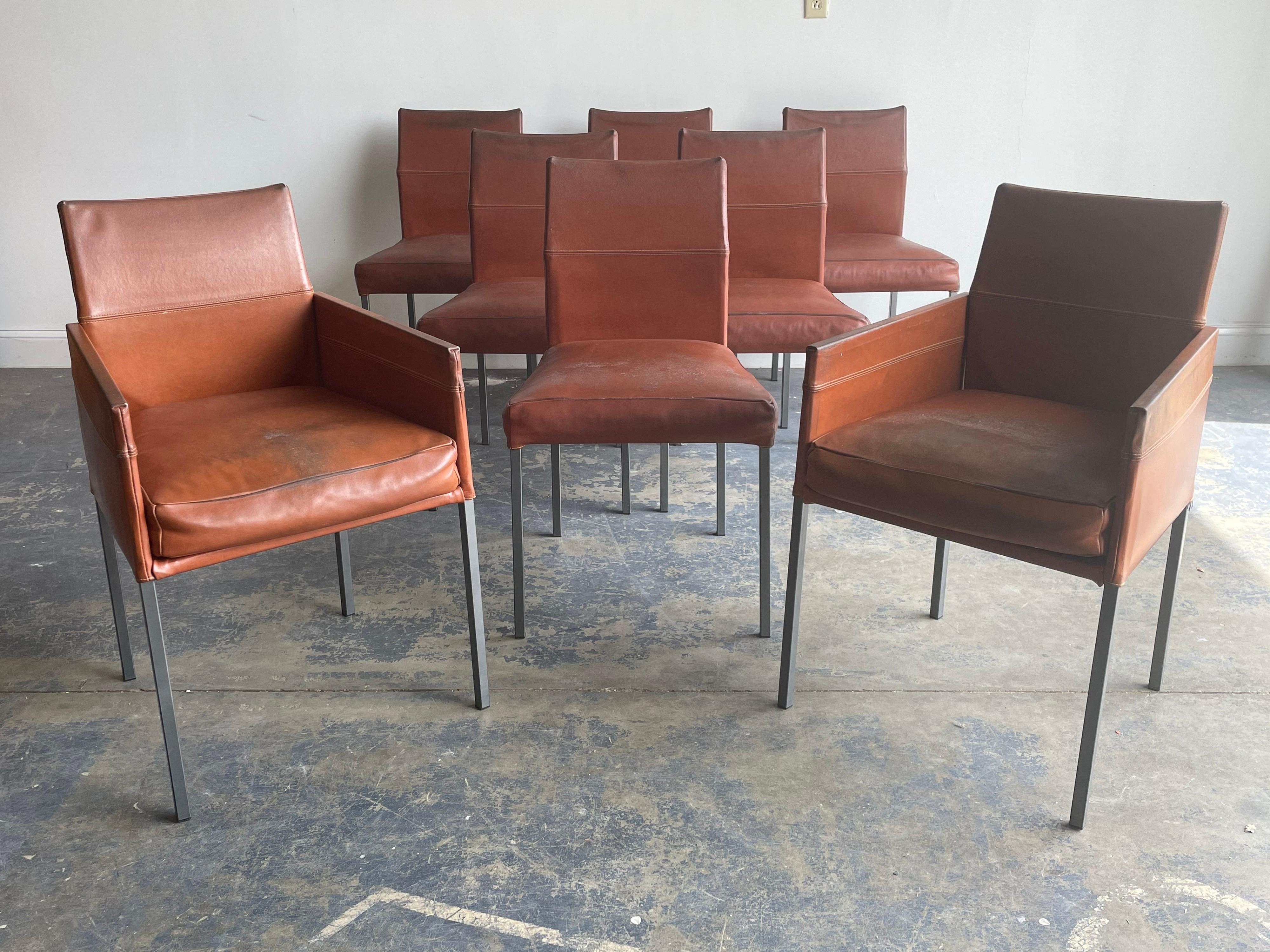 A set of eight dining chairs in patinated Leather with metal frames. Designer by Karl Friedrich Förster.