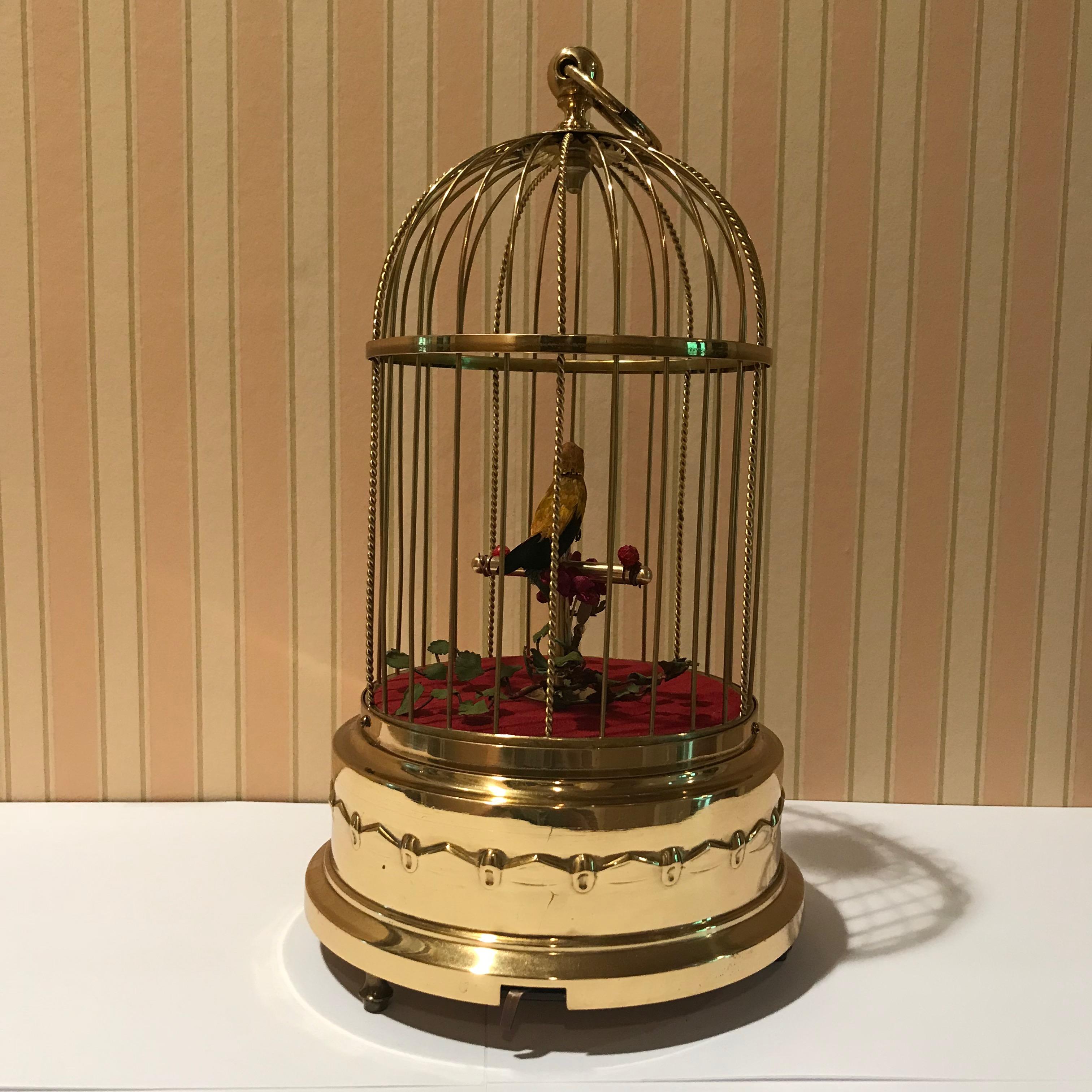 1920s German singing bird automaton by Karl Griesbaum. Makers marks stamped on base. Mechanical, wind-up singing bird in a polished brass cage. Working condition. Measures 6