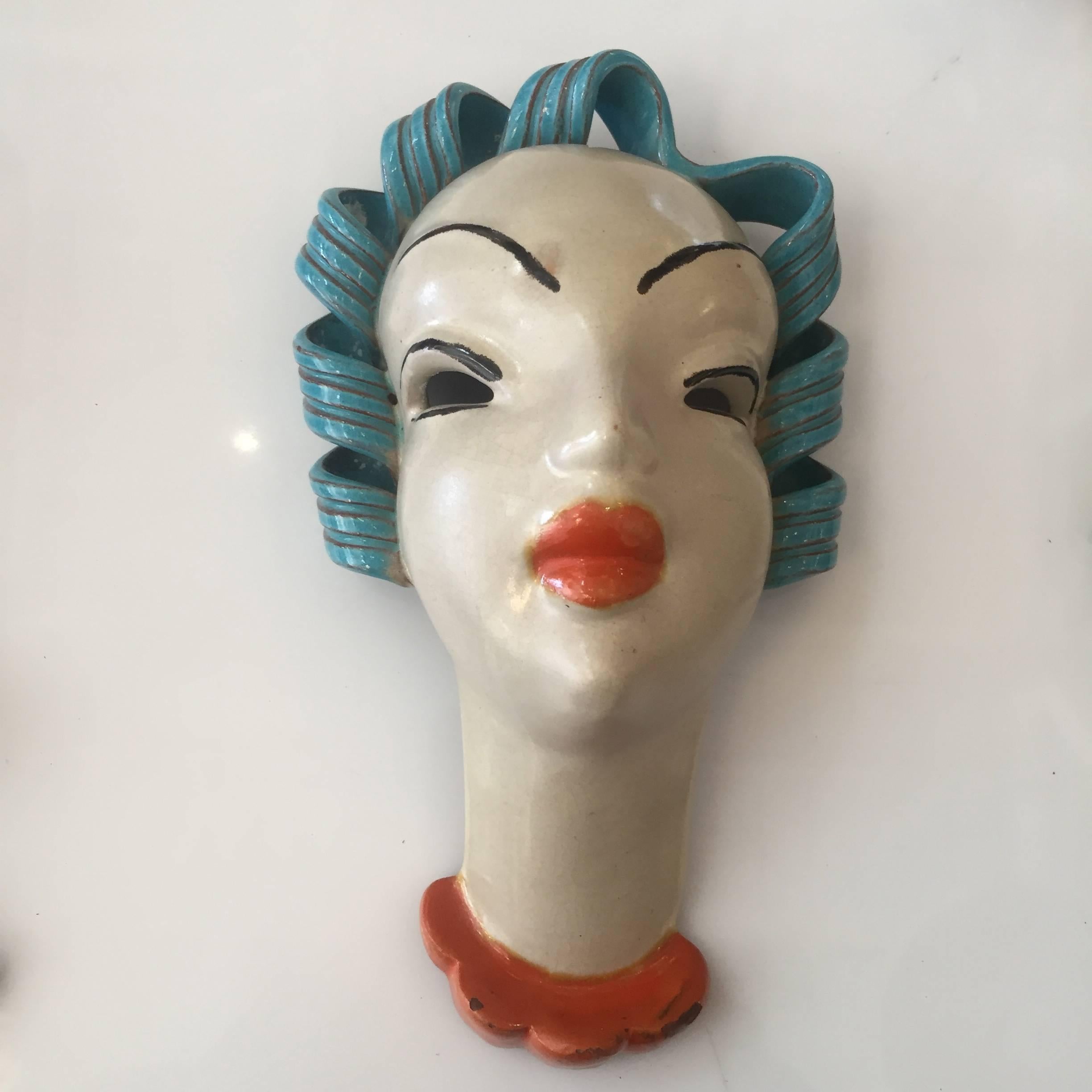 Beautiful Art Deco pottery mask by Karl Grossl (who also designed masks for Goldscheider and Keramos) for the Keramia factory.

Makers mark reads, 