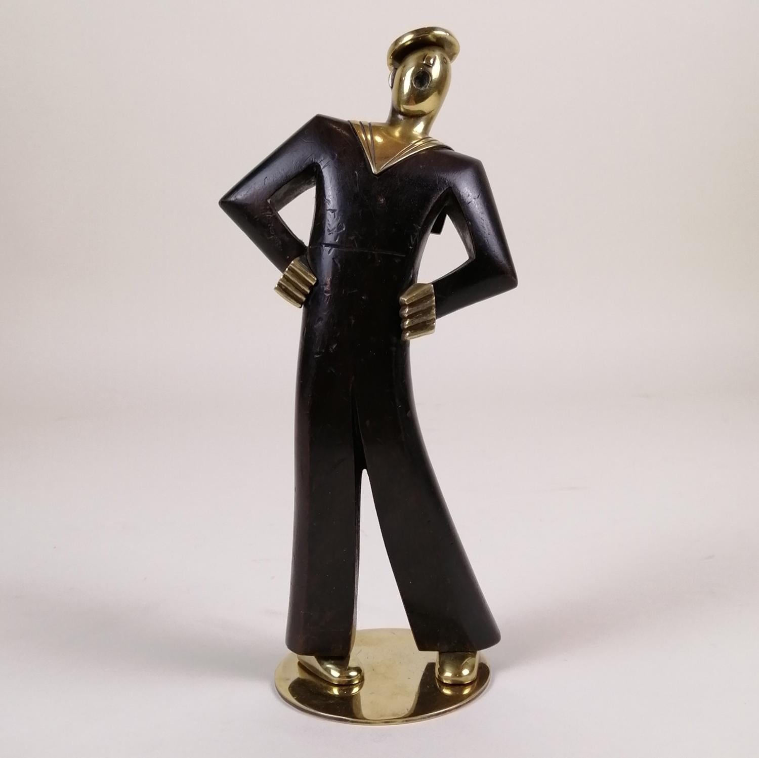 A 1930's Austrian ebonized wood and brass singing sailor. The sailor has wood body and brass head, hands and feet. Sealed on the bottom.