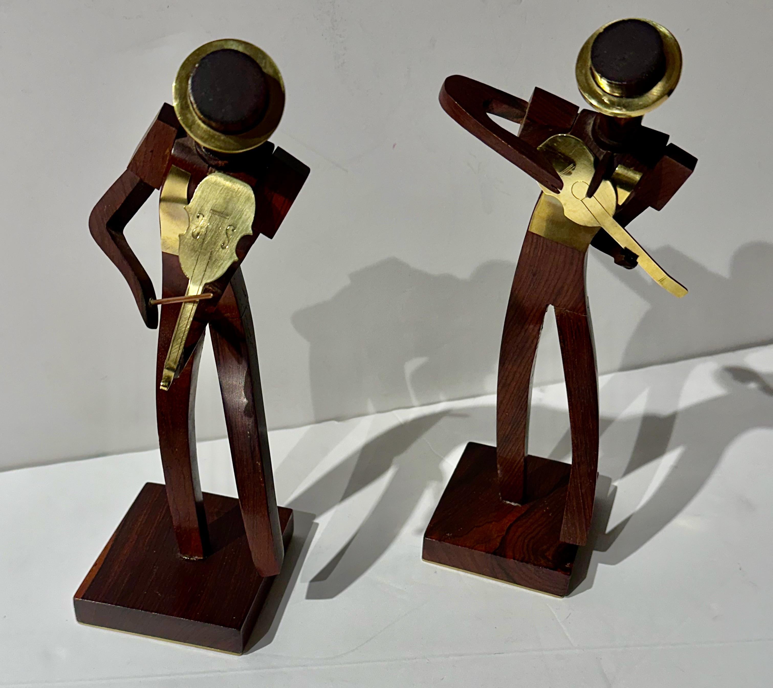 Karl Hagenauer’s Pair of Art Deco Bronze & Wood Musicians showcases his mastery in the Art Deco style. As an influential Austrian designer and goldsmith, Karl Hagenauer followed in the footsteps of his father, Carl Hagenauer, who established