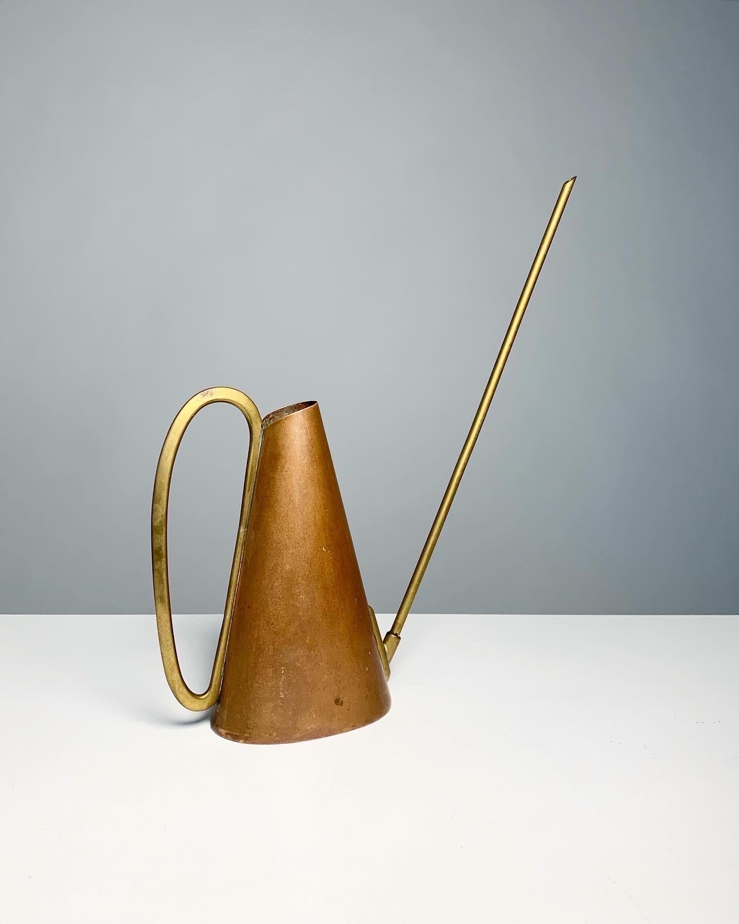 Karl Hagenauer watering can for his own workshop in Vienna, in the 1950s.

Hand-made of copper and brass, patinated over the years. Oxidation spot on one side.

Measures: Width: 35 cm
Depth: 8 cm
Height of can: 23 cm
Total height: 41 cm.

 