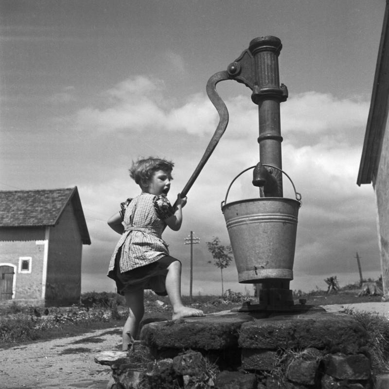 Karl Heinrich Lämmel Landscape Photograph - A girl taking water from a well, 1930 Limited ΣYMO Edition, Copy 1 of 50