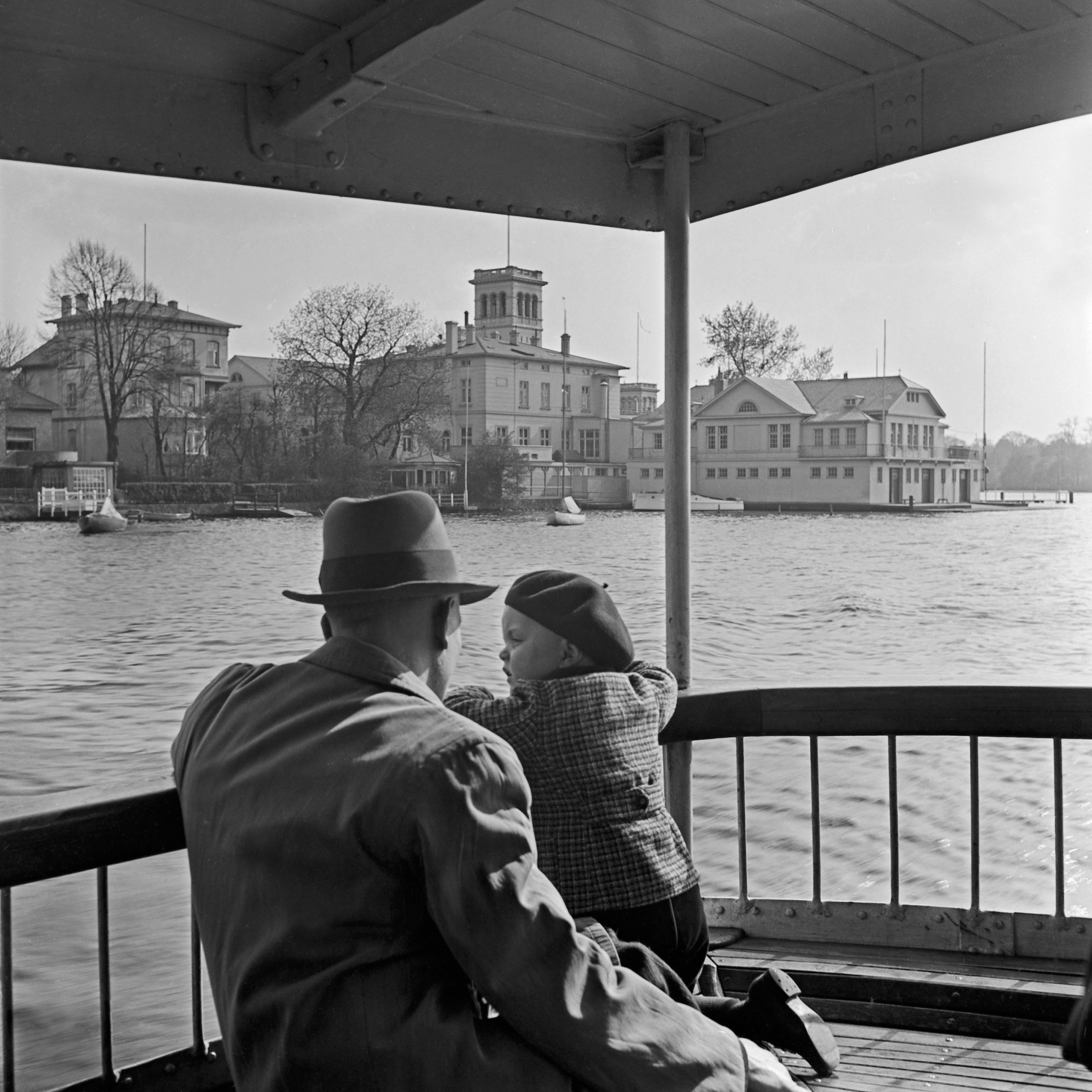 Karl Heinrich Lämmel Black and White Photograph - Man, child passing ferry house Hamburg Uhlenhorst , Germany 1938, Printed Later 