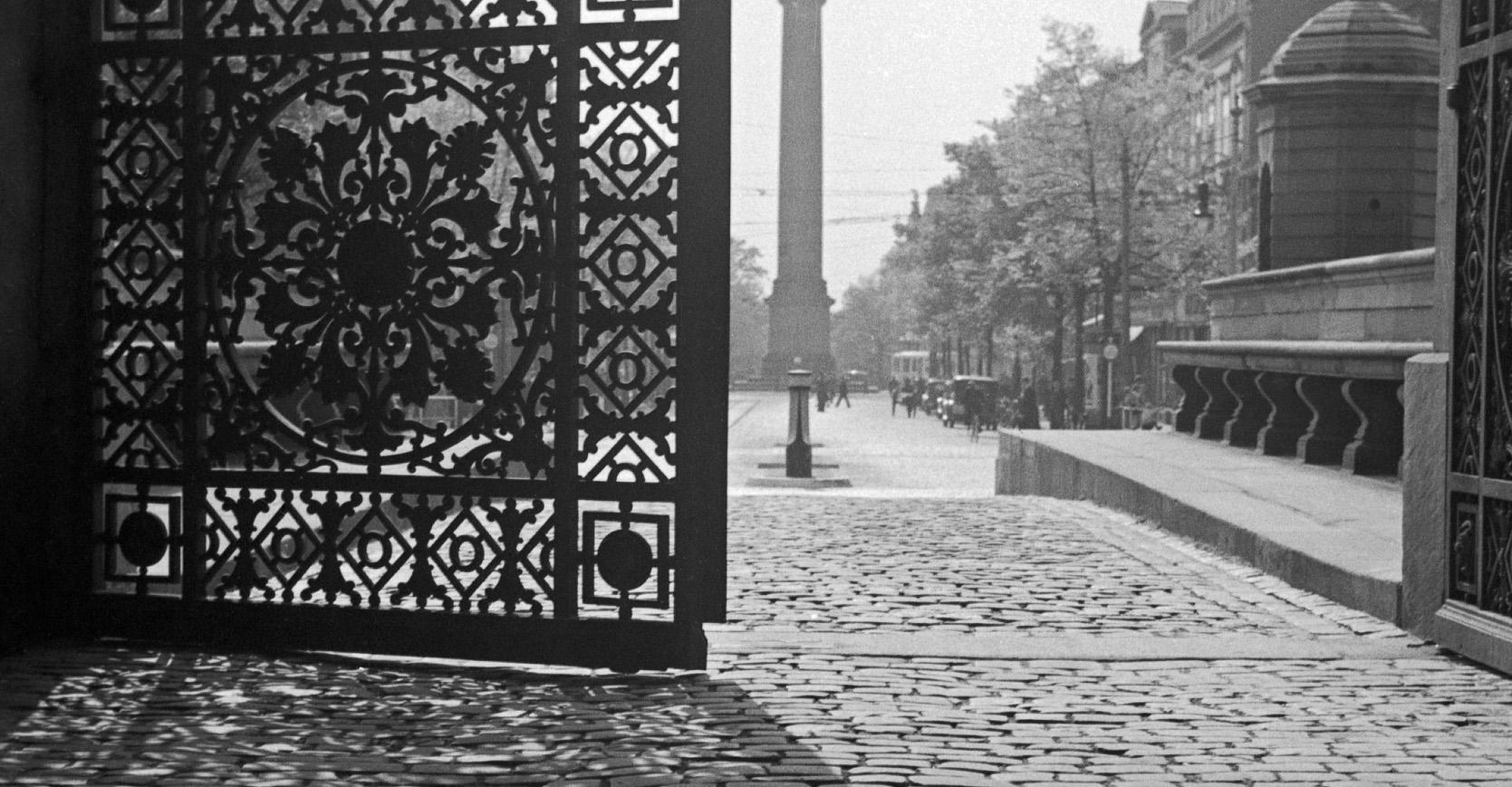 View from iron gate Darmstadt Castle to city life, Germany 1938 Printed Later  - Photograph by Karl Heinrich Lämmel