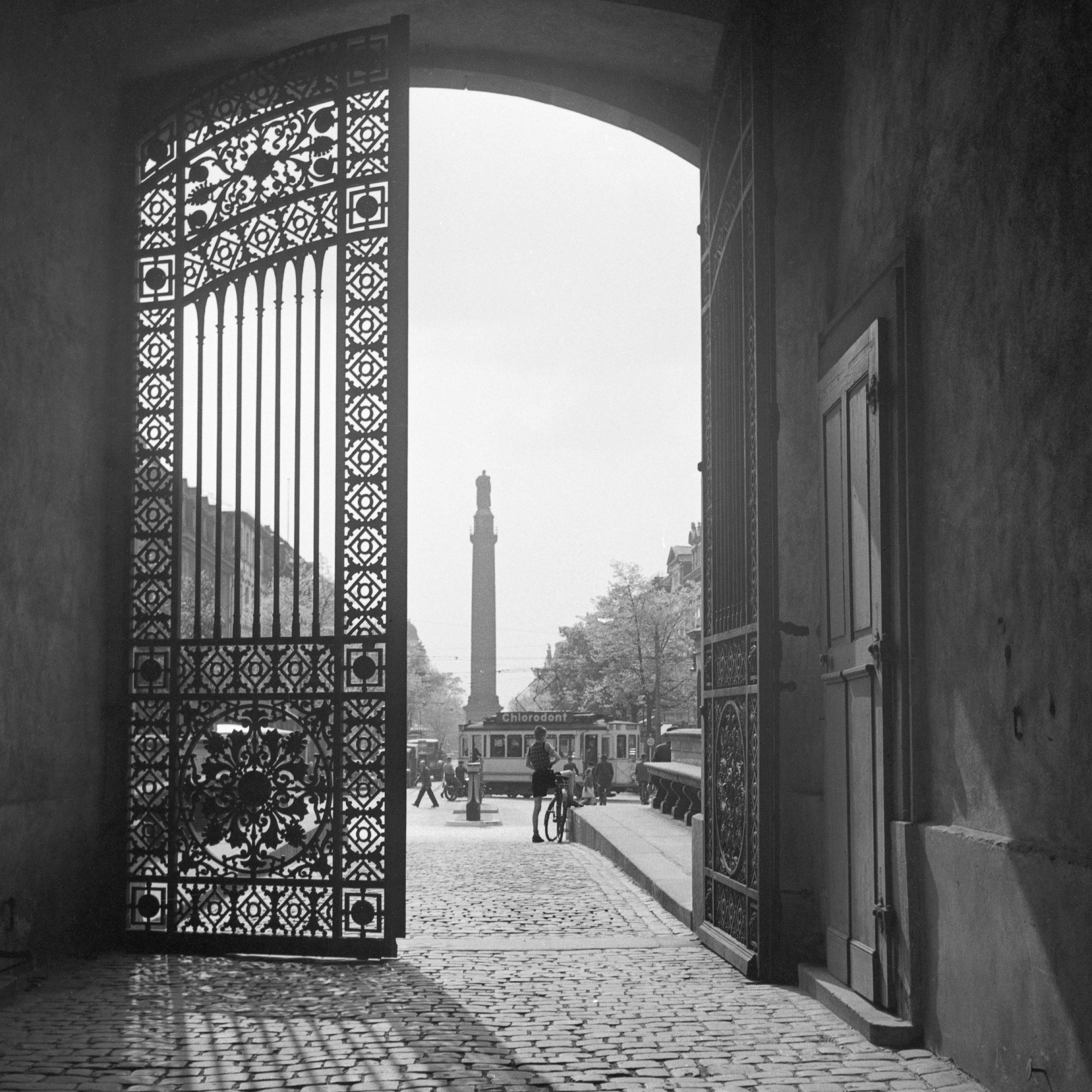 Karl Heinrich Lämmel Black and White Photograph - View from iron gate to city life Darmstadt, Germany 1938 Printed Later 