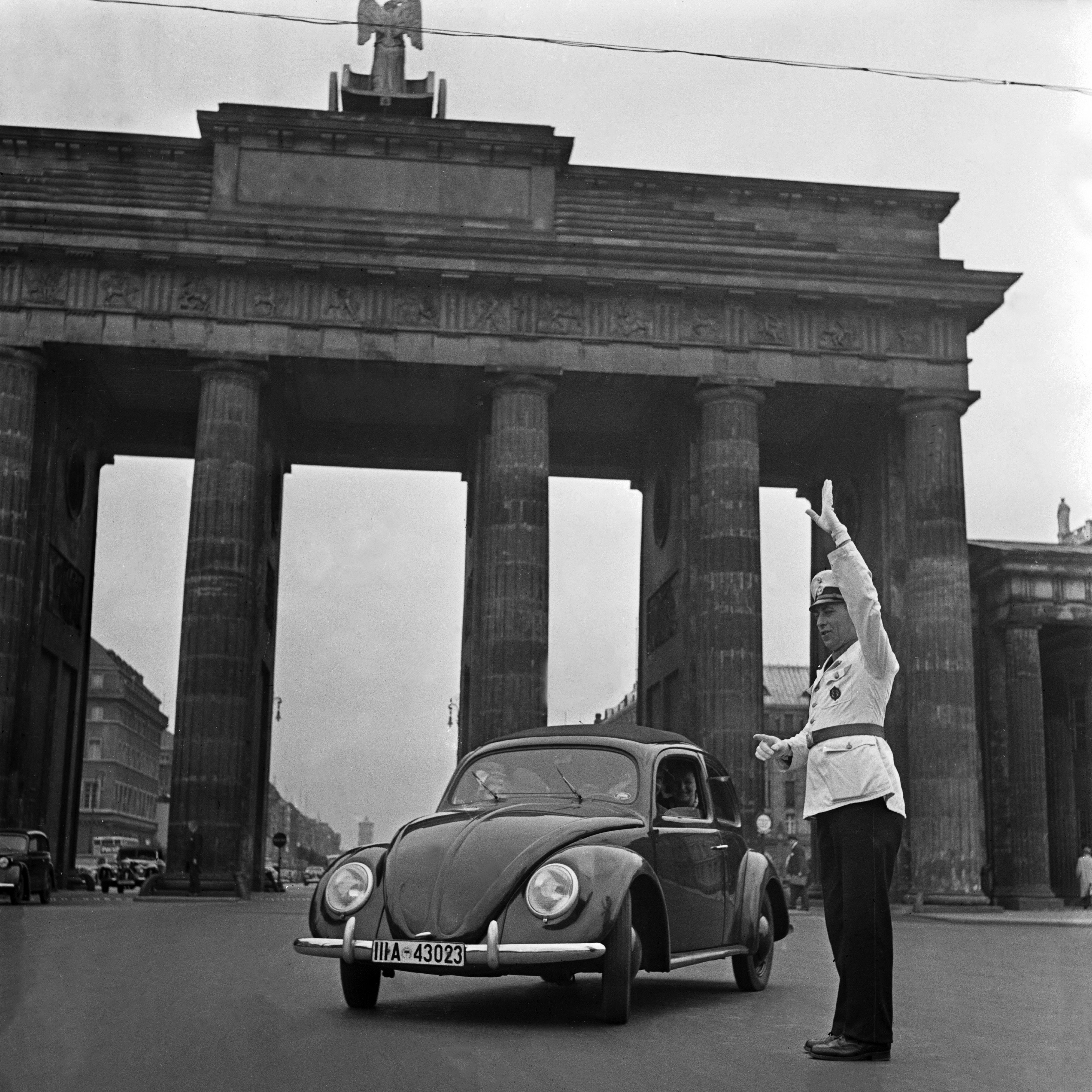 Black and White Photograph Karl Heinrich Lämmel - Le scarabée Volkswagen devant la porte de Brandenburg, Allemagne, 1939 Imprimé plus tard 