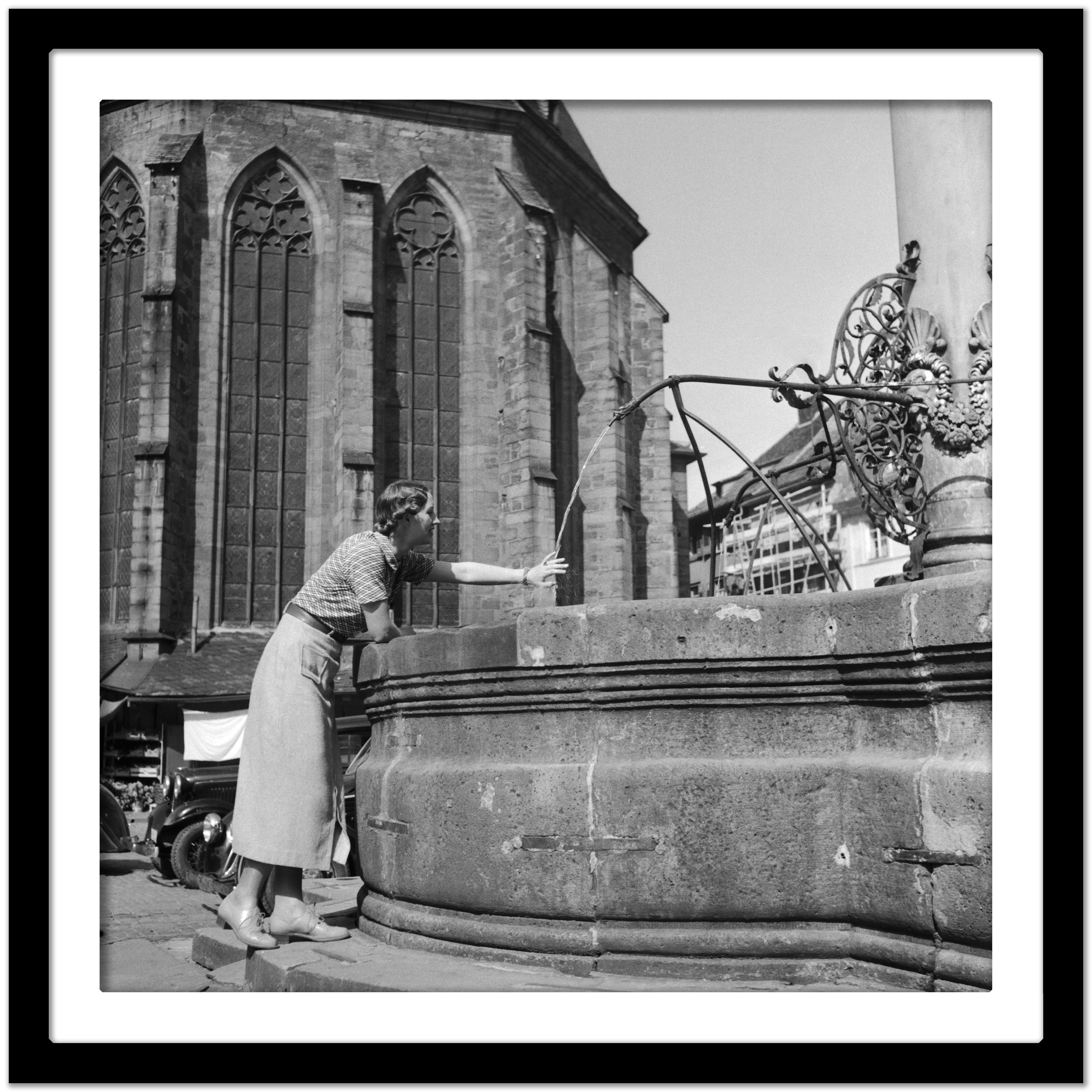 Woman, fountain, Heiliggeist church Heidelberg, Germany 1936, Printed Later  - Gray Black and White Photograph by Karl Heinrich Lämmel