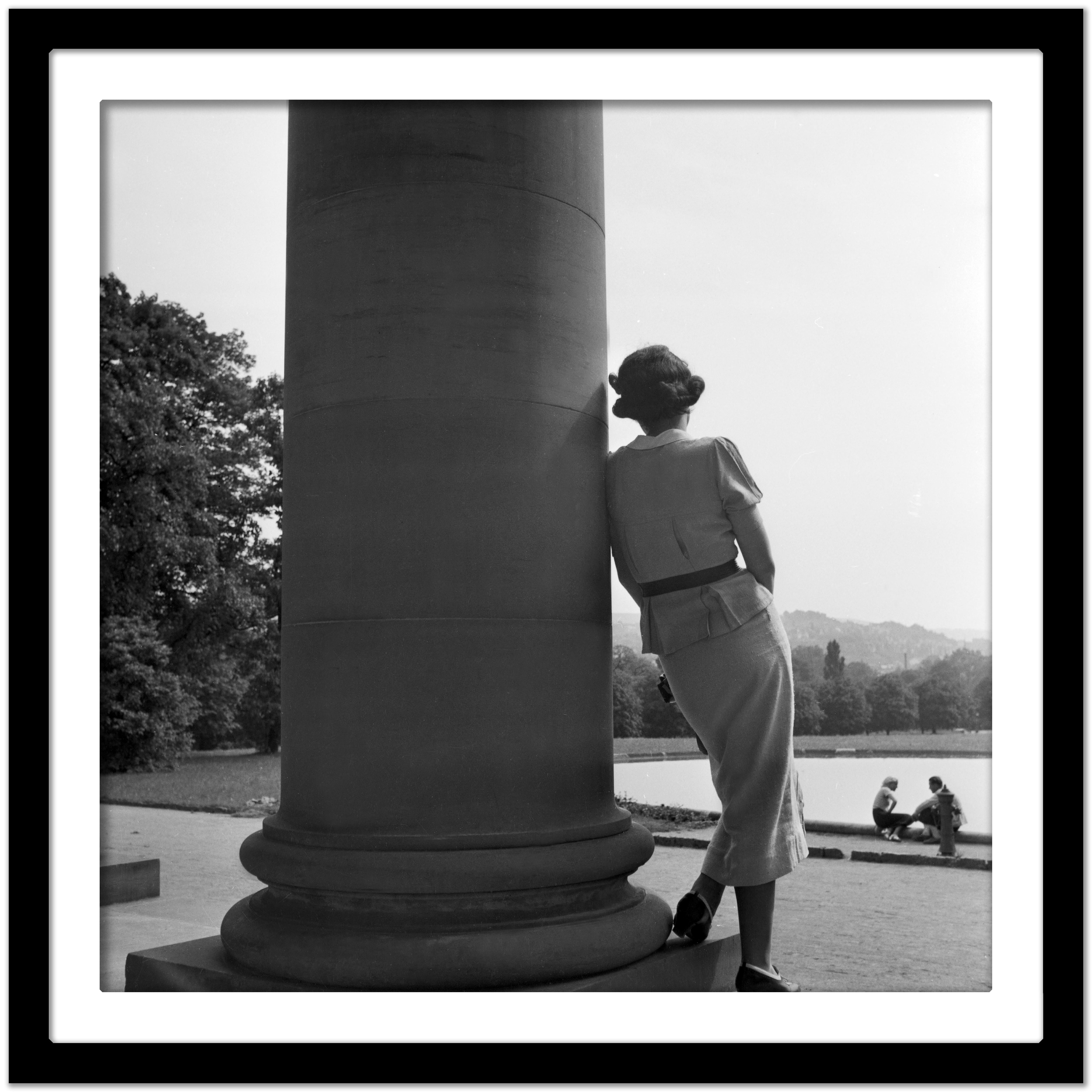 Woman leaning on column Cannstatt, Stuttgart Germany 1935, Printed Later - Black Black and White Photograph by Karl Heinrich Lämmel
