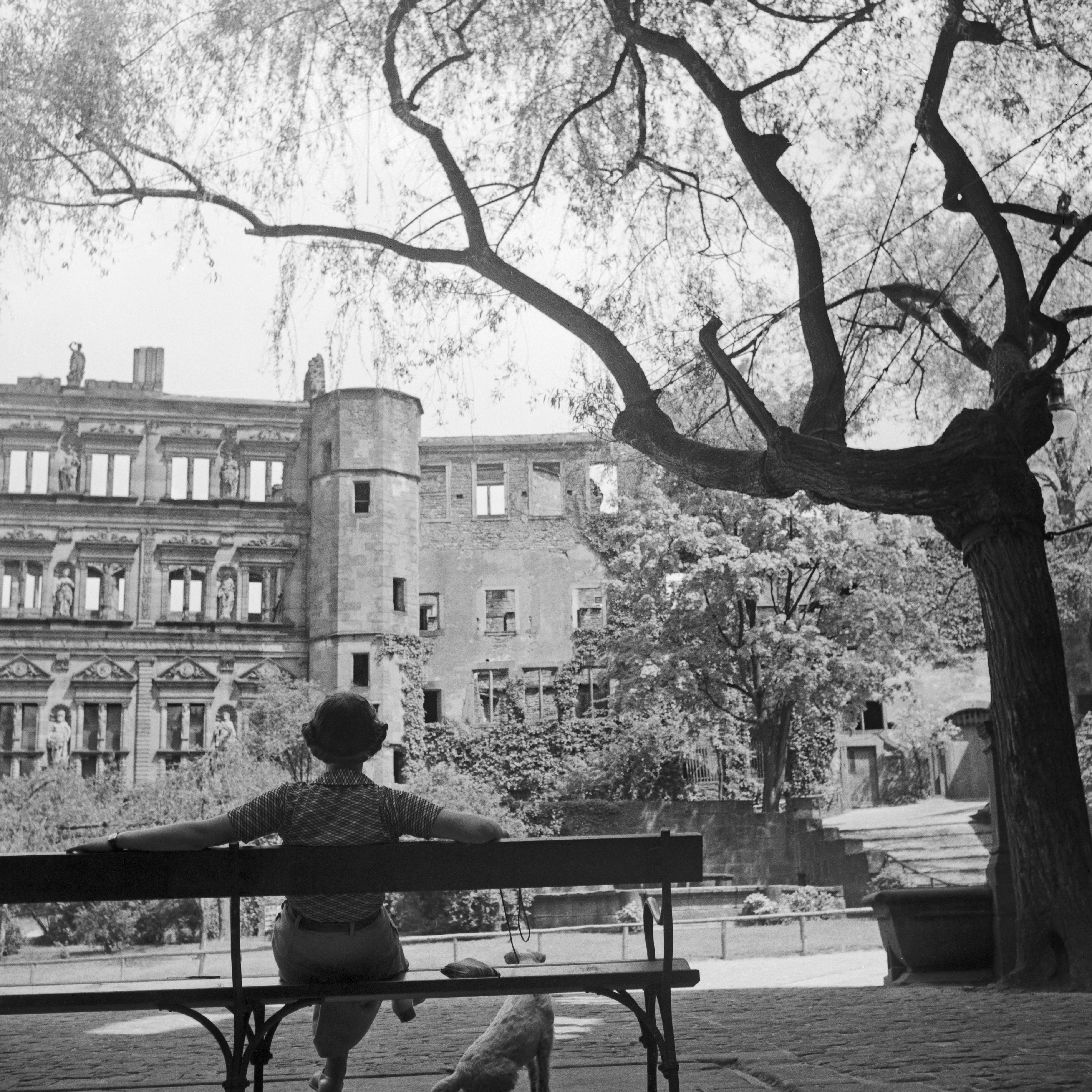 Karl Heinrich Lämmel Black and White Photograph - Woman on bench in front of Heidelberg castle, Germany 1936, Printed Later 