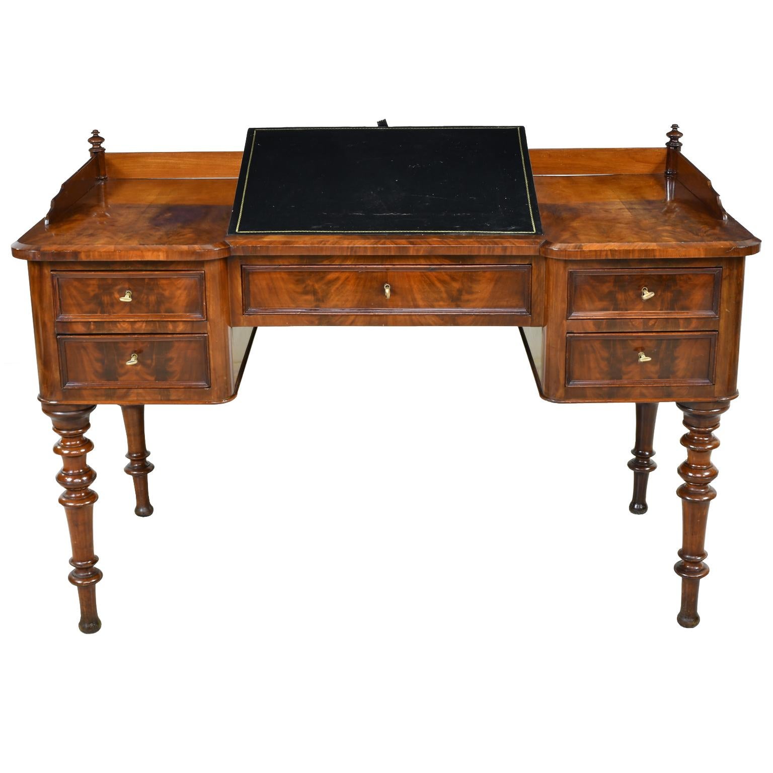 A very lovely Karl Johan writing desk in fine West Indies mahogany with adjustable black leather writing and reading surface above a center drawer that is flanked on each side by two drawers for a total of five storage drawers. Desk can float as it