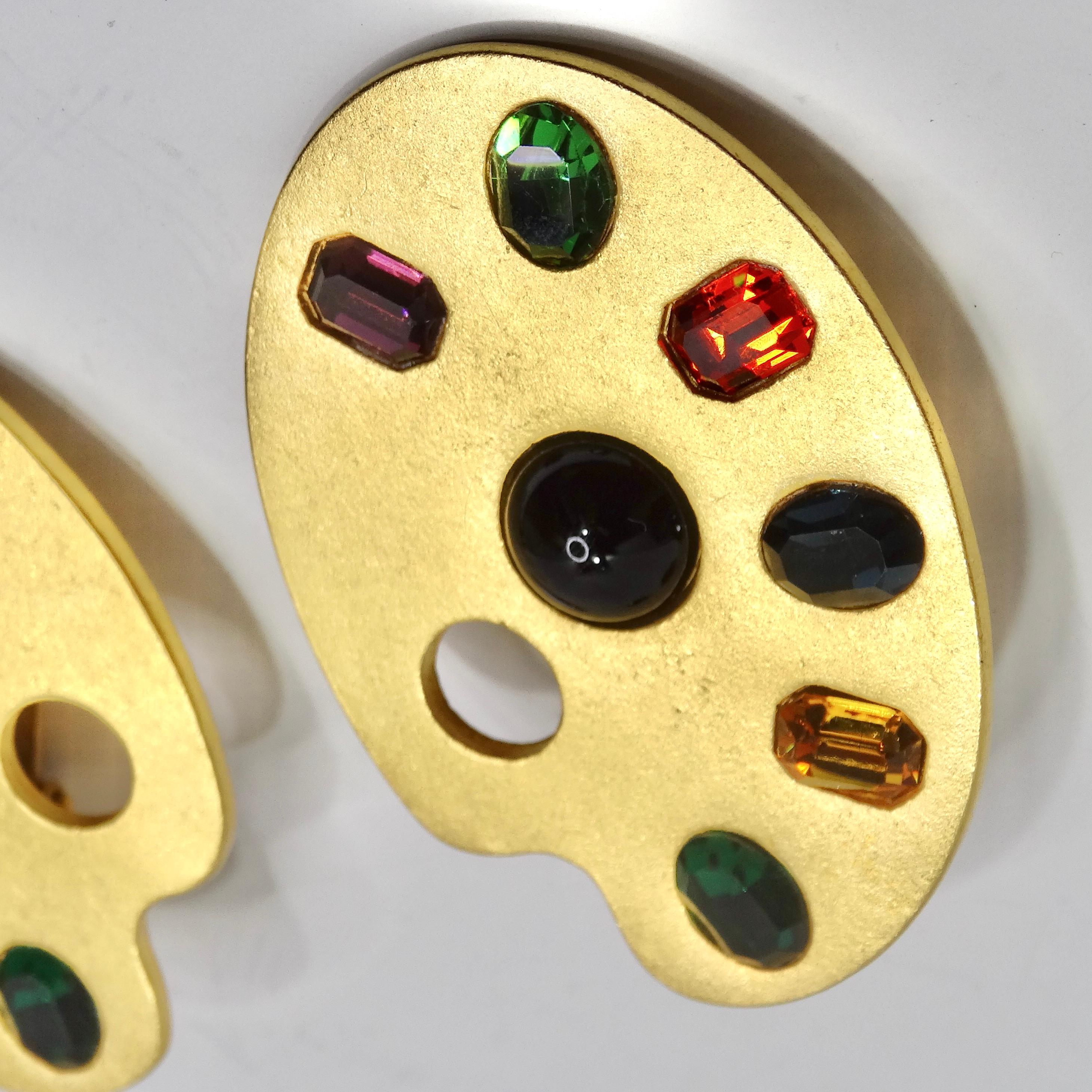 Introducing the Karl Lagerfeld 1980s Gold Plated Paint Palette Motif Multicolor Gem Earrings – a wearable masterpiece that transcends the boundaries of fashion and art. These stunning vibrant yellow gold plated earrings are ingeniously shaped like a