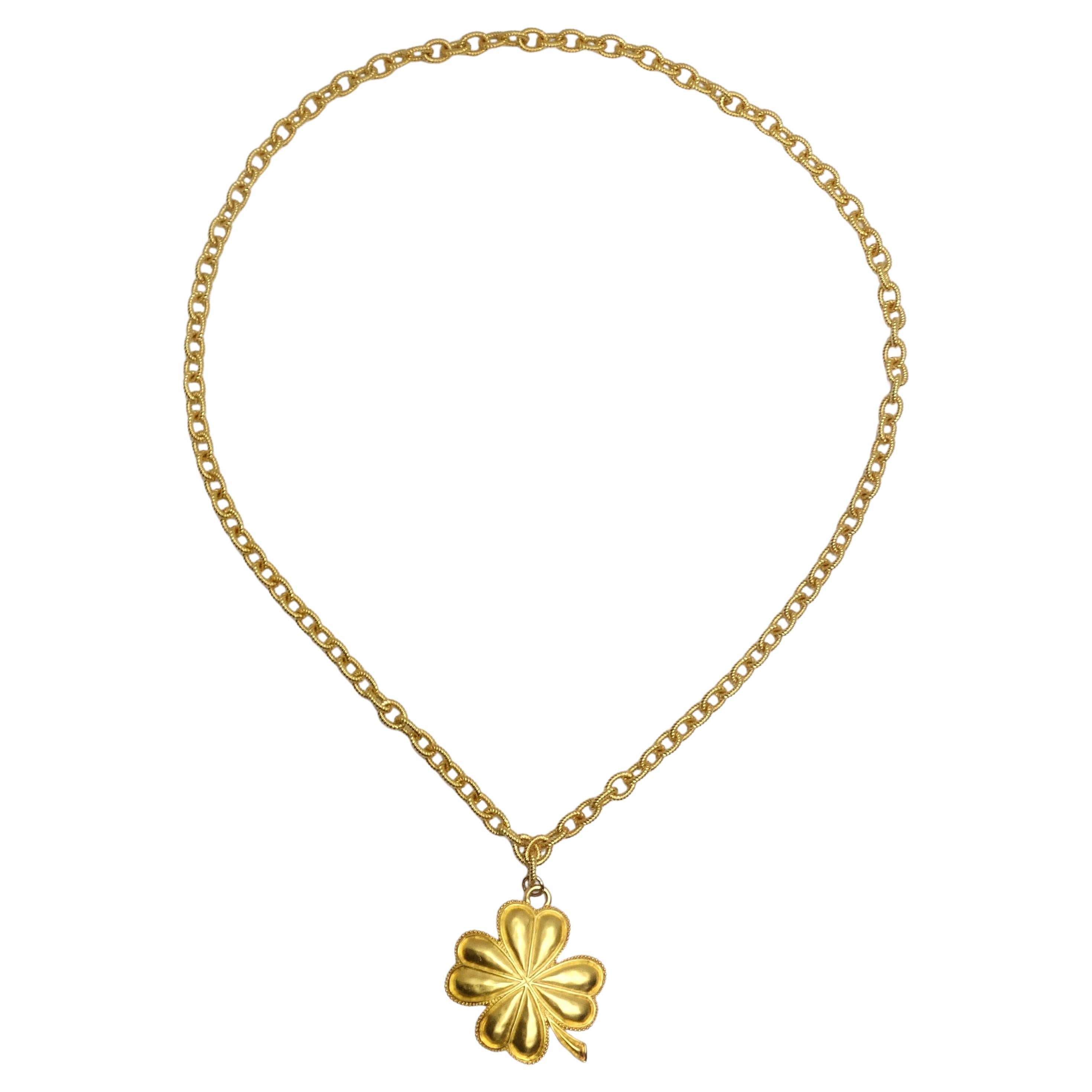 Introducing the Karl Lagerfeld 1980s Gold Plated Shamrock Pendant Necklace – your lucky charm! This stunning, shiny yellow gold plated necklace features a gold plated chain that gracefully gives way to a large, shiny gold plated shamrock pendant.