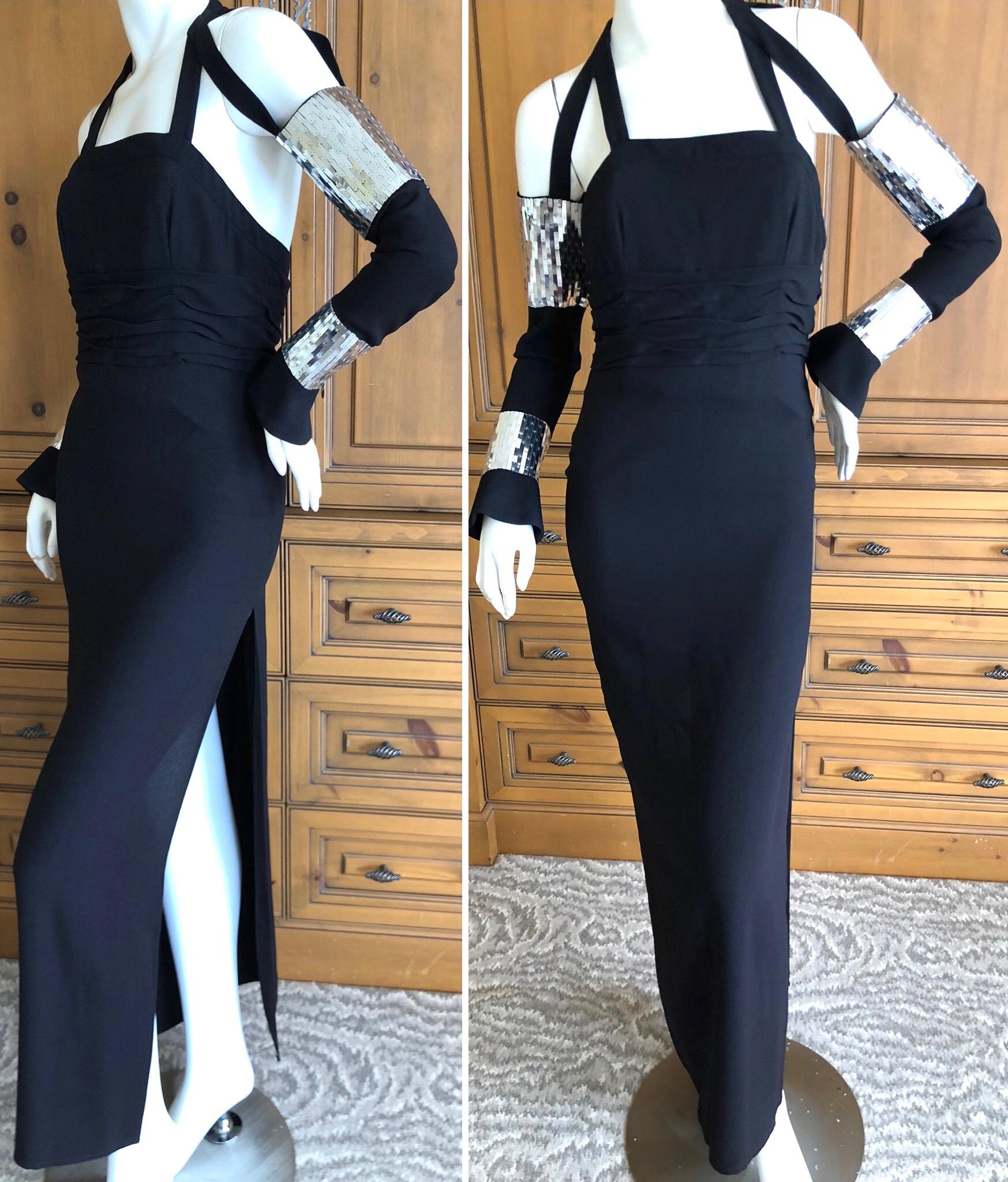 Karl Lagerfeld Collectable '84 Black Evening Dress w Bondage Strap Sequin Sleeves.
In 1984, fresh from his success as being named the designer of Chanel (1983), Karl Lagerfeld put out his first signature collection, at a very high price level.
 The