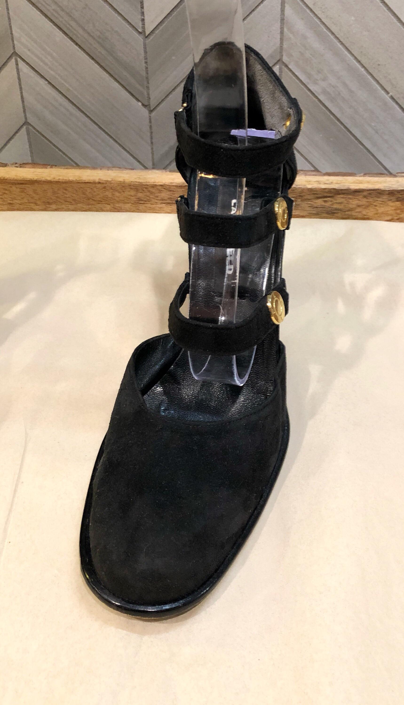 Collectible vintage 90s KARL LAGERFELD black suede leather bondage inspired high heel shoes! Features three straps across the ankle with elastic at each side. Gold logo encrusted studs at each outter strap. Block like heel makes it easy for all day