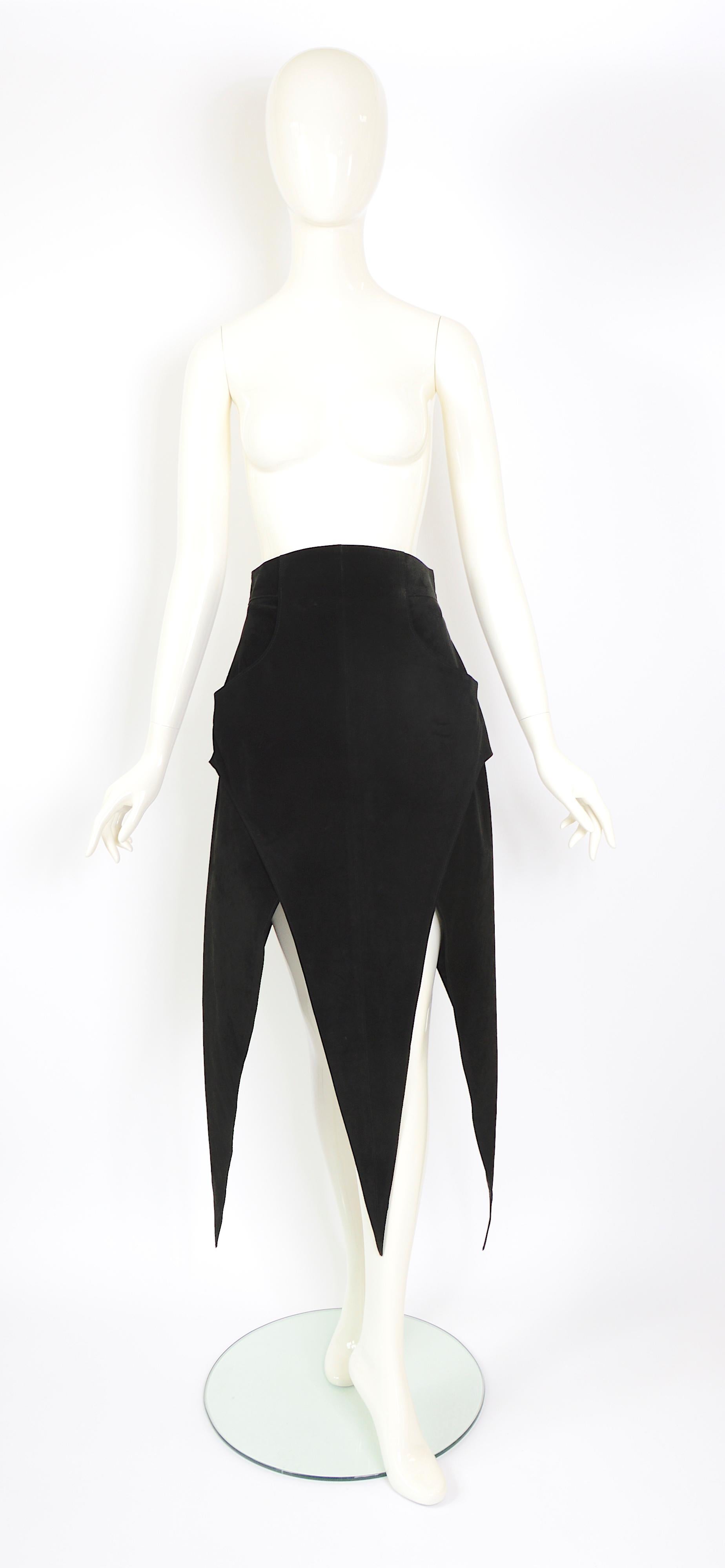 A gorgeous vintage fall/winter 1993  Karl Lagerfeld collectible black suede skirt. It has a wide waistband with overlapping pointed panels forming the skirt and featuring a back zipper, and front pockets. Fully lined in black silk.
Marked French